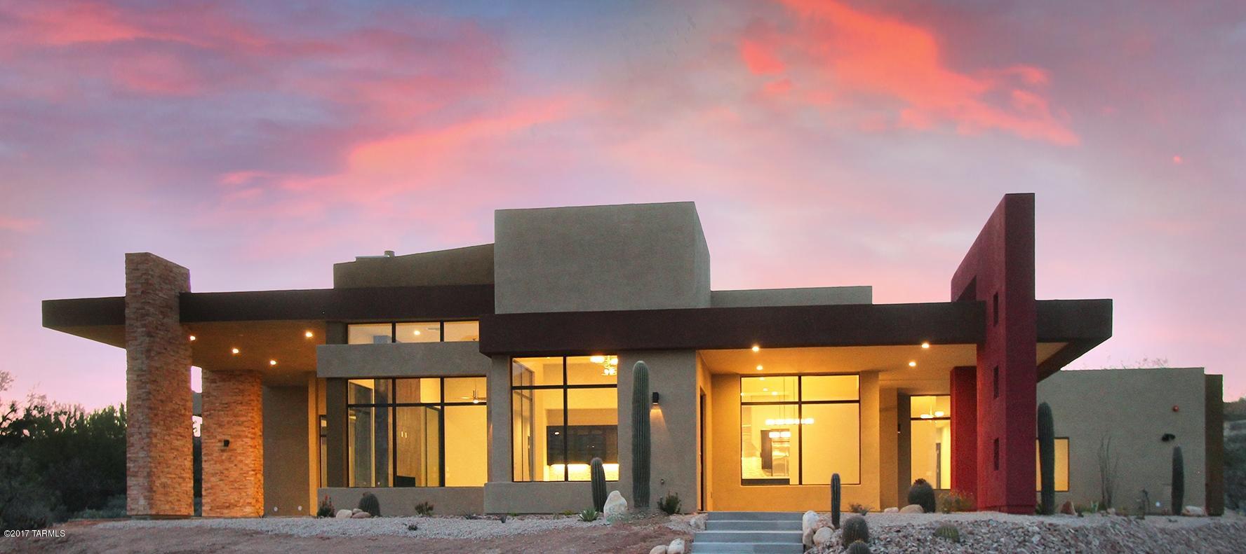 This newly constructed STUNNING Contemporary Custom home is a TUCSON ASSN of REALTORS TOUR WINNER!!! FEATURING: AMAZING VIEWS of the Santa Catalina Mountains from floor to ceiling GLASS WALLS; CUSTOM METAL FRONT DOOR; a WOW Great Rm w/Gorgeous Tile accented EURO-STYLE FIREPLACE; 5 bedrooms, all with Luxurious, TILE-accented ensuite bathrooms; an Office/Den (with closet) around the corner from Master Suite; a Bedroom/Game Room with double door entry; Gourmet Kitchen showcases SS VIKING appliances surrounding a huge Island with CARRARA MARBLE countertop. Same beautiful marble is featured at bathroom counter tops. All this and more in an EXCLUSIVE, 21-lot GATED COMMUNITY of MILLION dollar homes! Come see it today.  Agent & Builder related.