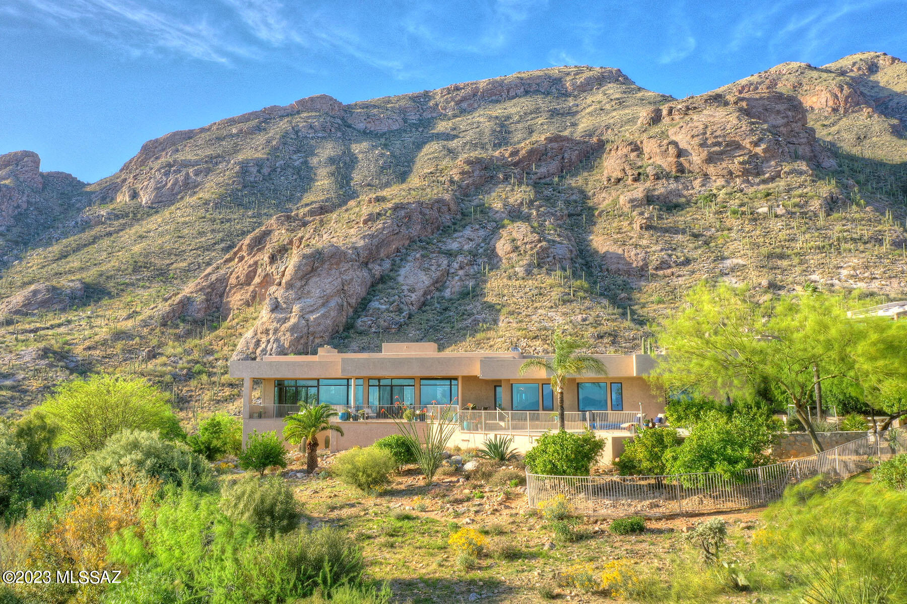 THIS IS IT! An absolutely gorgeous home at the top of Skyline Country Club with quality living at its finest. You won't believe the amazing Panoramic city views as well as majestic Catalina mountain views. A Contemporary style home is an entertainer's dream and has just about everything you could want in a home. Custom built by well-known Tucson builder LJ McCreary Home, Inc., and completed in 2007.  Enter through the tall glass front doors where you are greeted with spectacular city views that will take your breath away. Without taking a step, just spin around and the mountains are so close you will feel like you can touch them. This gorgeous  4-bedroom split floor plan with 4 bathrooms, study, and an impressive home theatre room.  Just trying to describe this home doesn't do it justice This beautiful home has exquisite porcelain tile flooring throughout, 12ft+tall ceilings, floor to ceiling windows, gourmet kitchen, custom coffee bar and wet bar for entertaining. There is a separate entrance from the east side of the home that enters right into the 1st primary bedroom with city views. En-suite bathroom, also has city views, a jacuzzi tub, separate shower, dual sinks, huge walk-in closet and private water closet including a bidet. 2nd primary bedroom with beautiful city views and En-suite bath with steam shower, dual sinks, another huge walk-in closet, and separate water closet with bidet. On the other side of the home are the 2 remaining large bedrooms with a Jack and Jill bathroom.  Three car garage has 2 large storage closets. And did we mention the solar powered pool and spa where again you can get lost in the city views.

Skyline Country Club Estates is a luxurious and exclusive residential community located in the foothills of the Santa Catalina Mountains in Tucson. The community features custom-built homes with breathtaking views of the city and the surrounding mountains.

Living in Skyline Country Club Estates provides residents with access to a wide range of amenities, including a championship golf course, a fitness center, tennis courts, and a swimming pool. The community also has a clubhouse that hosts social events and activities for residents.

One of the unique features of Skyline Country Club Estates is its proximity to the natural beauty of the Santa Catalina Mountains. Residents can enjoy hiking, biking, and horseback riding on the trails in the nearby mountains.

The community is also conveniently located close to shopping, dining, and entertainment options in Tucson, making it easy for residents to enjoy all the city has to offer while still enjoying a peaceful and exclusive living environment.

Overall, the combination of luxurious homes, stunning views, exceptional amenities, and access to natural beauty make Skyline Country Club Estates an attractive place to live.