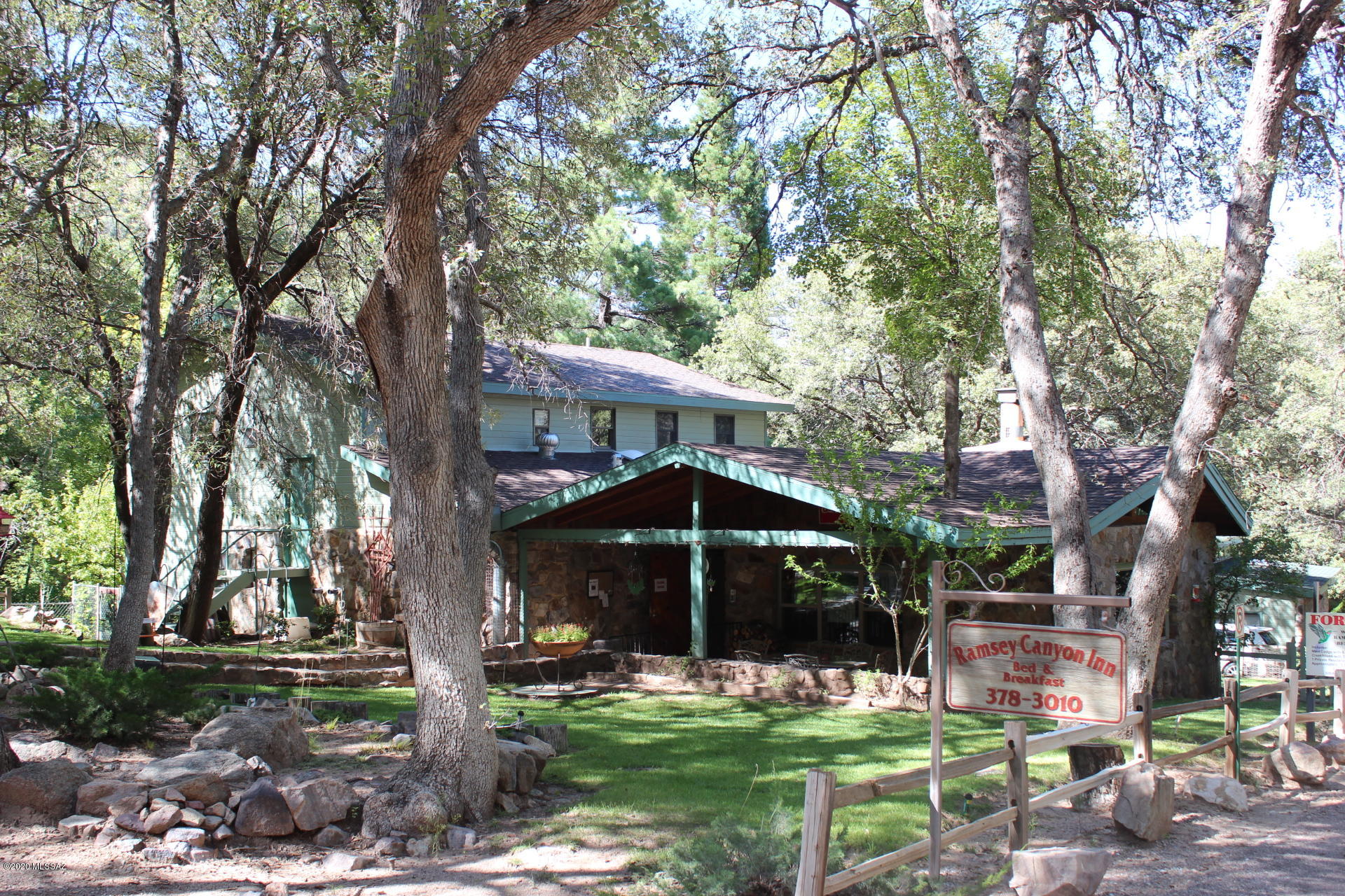 WORLD FAMOUS RAMSEY CANYON INN is now available! This has been a successful B&B for over 32 years. Incredible serene location at a cool 5,500' elevation in the spectacular Ramsey Canyon adjacent to the renowned and protected Nature Conservancy Preserve & National Forest on 2 sides. This great income property consists of a beautiful main lodge with 6BR/6.5 private baths, a triplex & a private managers house all situated on the most magnificent 10 heavily wooded acres with grass, flowers & a fantastic creek! It is being offered turnkey with all furniture, linens, kitchenware, supplies...The owners have recently completed major renovations and everything is in excellent condition. This is the Hummingbird Capital of the USA! THE INN WAS VOTED BEST PLACE TO STAY IN THE SIERRA VISTA REGION!! THIS IS A BIRDWATCHERS PARADISE! The property has multiple potential uses. It can serve as a Private Family Compound, a Healing Center, an Assisted Living Center, a Church/Children's Camp or a Corporate Retreat to name a few. The lodge could also be the main residence & the triplex & manager's house could be excellent rentals for additional income. The kitchen has just been remodeled and the lodge has a new roof as of July 2018.That completes the full renovation of the property! The canyon views are magnificent & there are miles of awesome hiking trails nearby throughout the Huachuca Mountains. There are other beautiful building sites available if desired. There are many varieties of trees including maple, sycamore, oaks, junipers, numerous fruit trees and 2 California Redwoods planted in 1963. There are really 4 seasons here at this location and elevation. This is truly a one-of-a-kind property in a very peaceful, remarkable, blessed, quiet setting. Come visit and you will not want to leave!