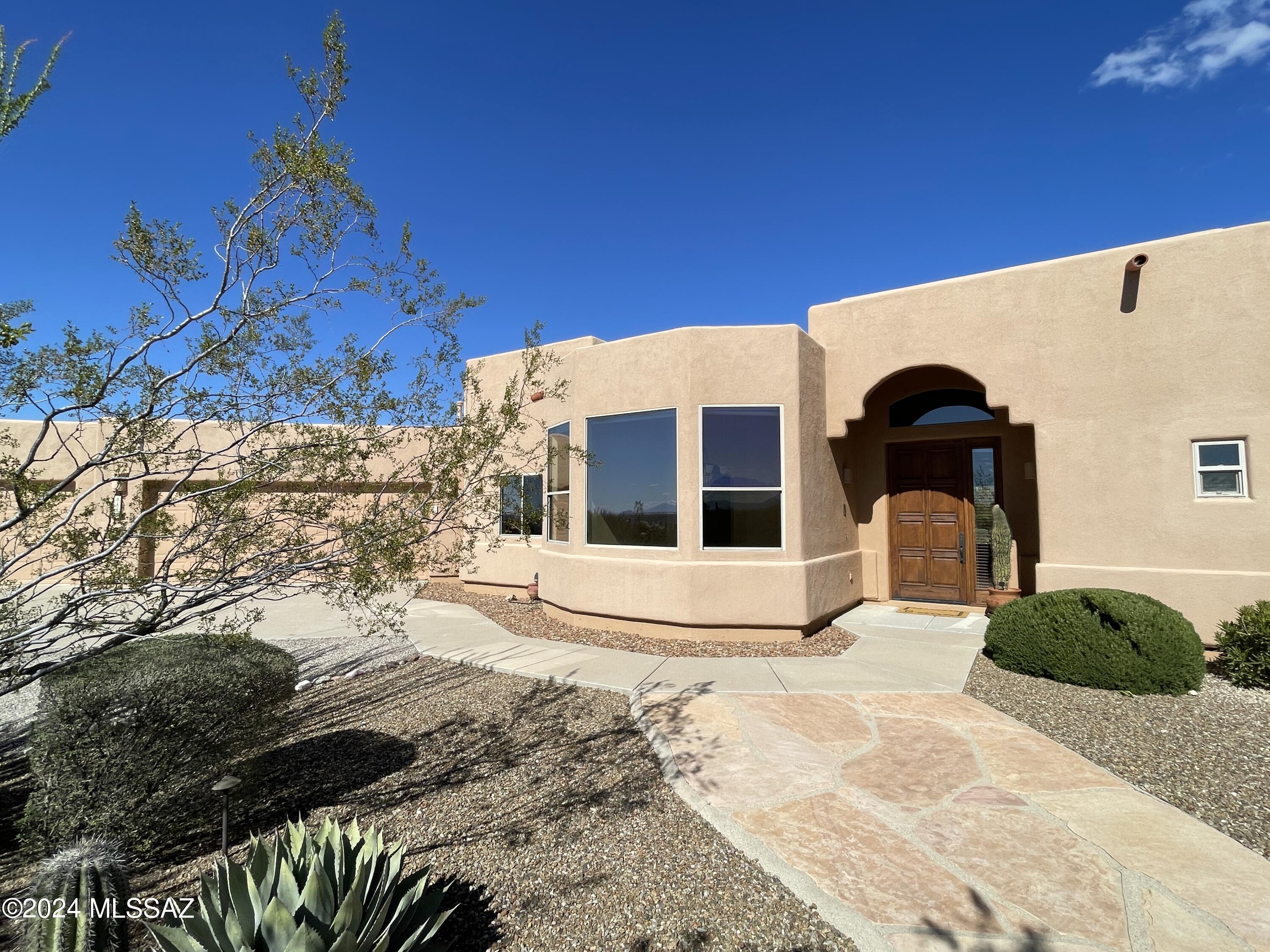 Tranquility of living on this elevated  2.62 acre lot home with  sweeping mountain views, gorgeous city lights, and sunsets you can't miss!  Lush natural desert surrounds this incredibly well maintained 3 bedroom  + den, 2.5 bathroom, 2767 sq ft home with additional sq ft in 2 rooms off garage- Workshop with 220 amp and separate storage room (or for workout, art, more workshop, whatever you need)!   Custom mesquite door is your entry to an open, functional floorplan- great room style with fireplace as a focal point (has easy start remote). Large dining room contains 2 arched entries and large windows capturing the surrounding beauty of the Sonoran Desert! Large kitchen with Viking gas chef's stove, tons of storage, pullouts, breakfast bar, and breakfast nook make this an inviting space