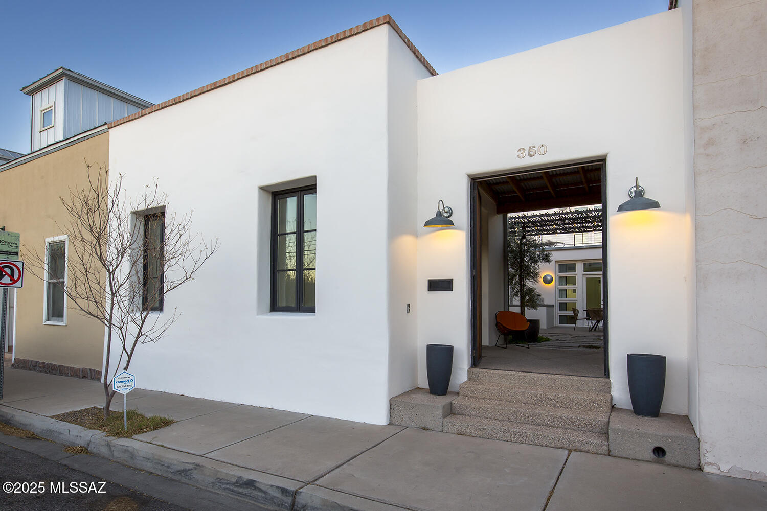 Located in the heart of the historic El Presidio Neighborhood, this stunning 3-bedroom, 3-bathroom townhome seamlessly blends contemporary design with timeless charm. Franklin Court consists of 6 additional townhomes built in 2005. Thoughtfully crafted to maximize space and natural light, the home boasts polished concrete and hardwood floors, creating an open, airy ambiance.
A striking wall of windows invites the outdoors in, connecting the spacious living area to a serene central courtyard. This private retreat features an Ocotillo-covered shade structure, offering a beautifully filtered light—ideal for relaxation and entertaining. The courtyard is further enhanced by a built-in gas barbecue and a soothing fountain, making it a true entertainer's dream.
The well-appointed kitchen