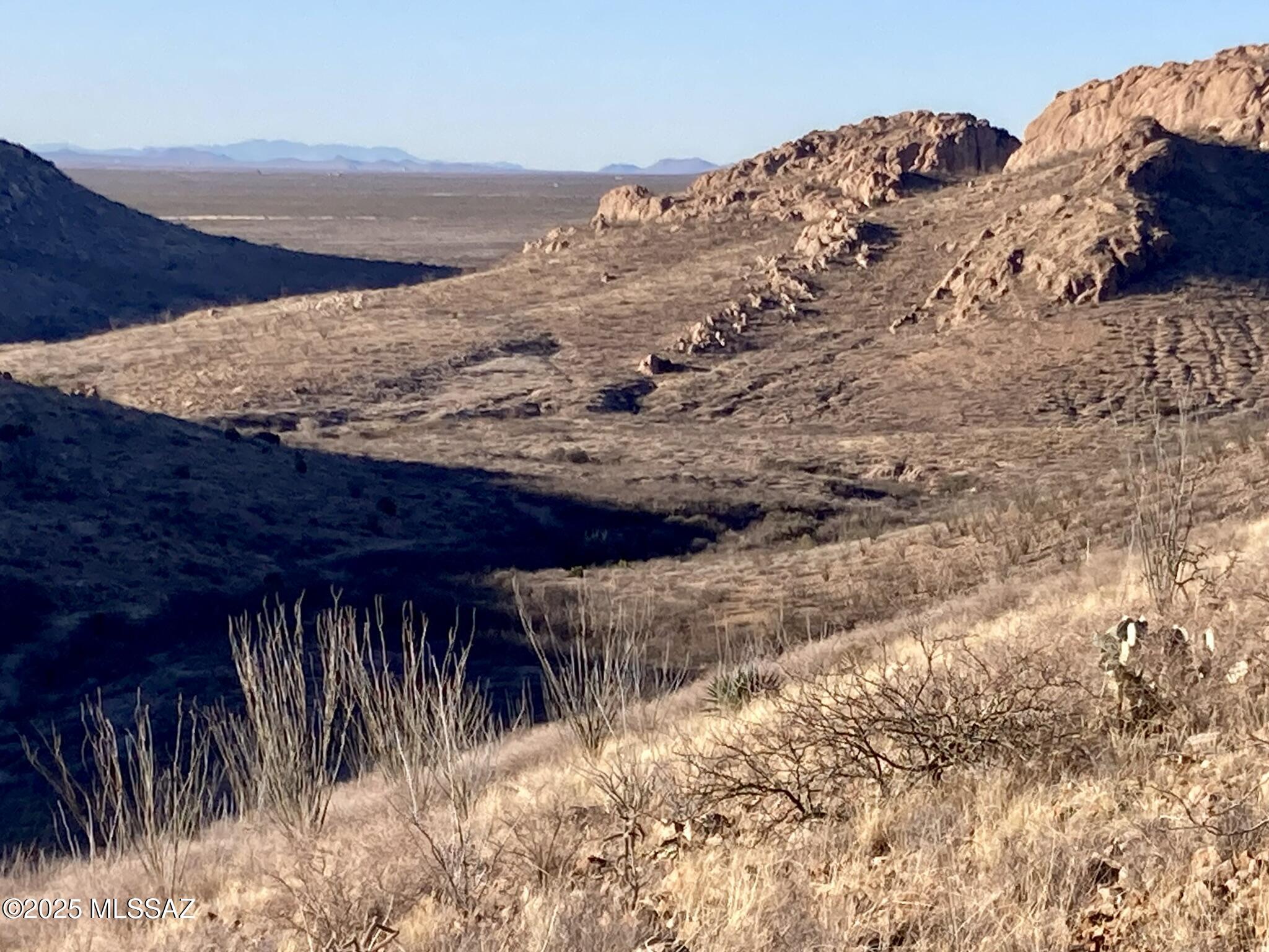 This is way out there but well worth it, 235 acres of you own desert mountain sanctuary. This is not land locked, but actually has legal and physical Access from 2 different directions.  This is actually 3 parcels 405-45-052-F, 405-45-053-S and 405-77-098. Sits up against State Land on TWO sides! The property is located east of Leslie Canyon Road, north of Calle Principal, and south of Mud Springs Draw.   It affords amazing sunset views and views of Castle Rock to the North.  It's also got some really interesting rock formations onsite.