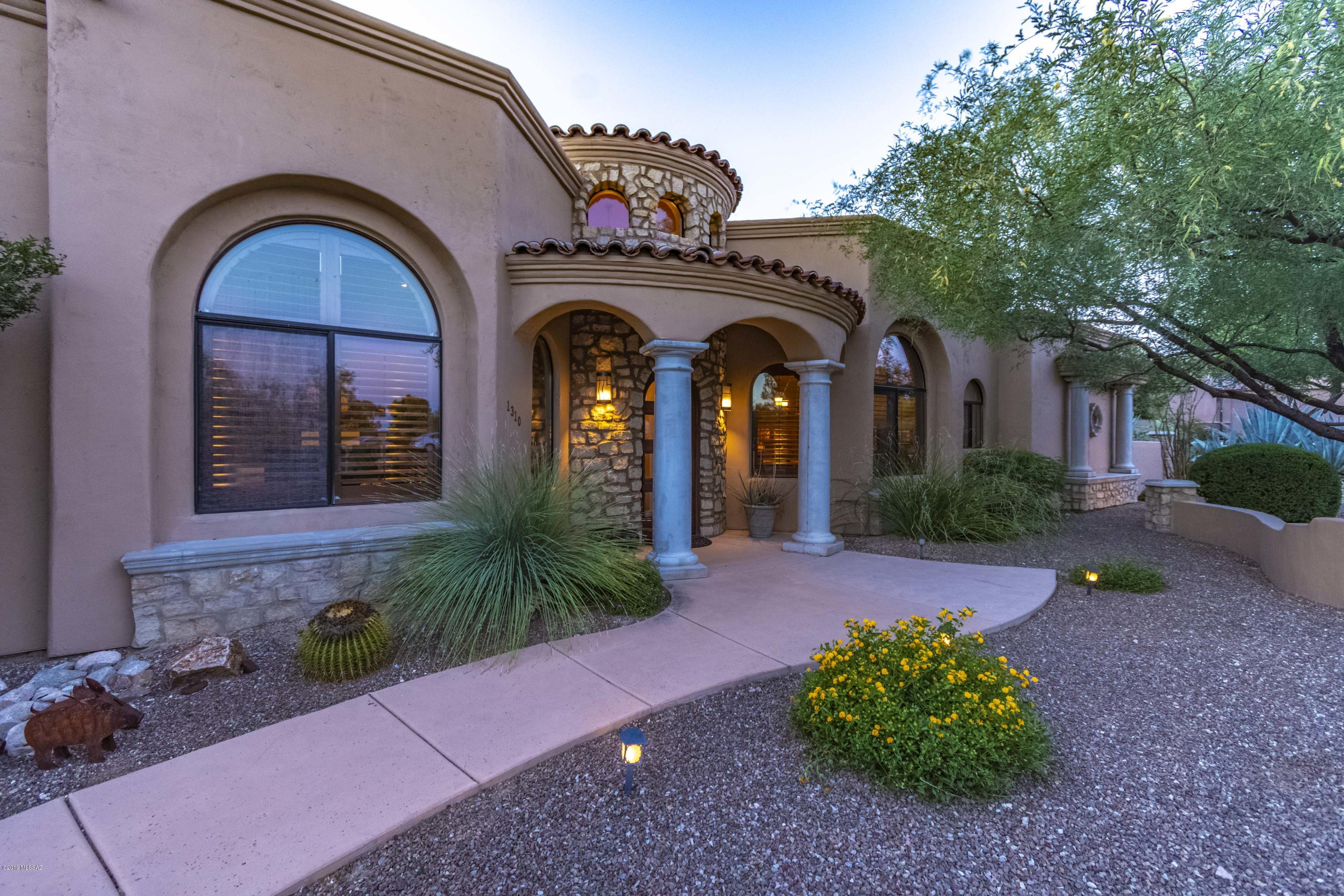 Stunning custom home in Casas Adobes. This Entertainer's Delight has a kitchen that will satisfy the most discerning chef with double ovens and a pot filler faucet. Great room with wet bar.  Soaring ceilings and windows make this home bright and airy. Sparkling pool and jacuzzi near the built in BBQ with Mountain Views. Custom iron work on the gorgeous great room fireplace, french doors to open patio and around the pool. Custom shutters in front of the home and rolling blinds in the great room. Scored colored concrete.  Gorgeous stone work. Recovered barnwood fireplace in the master bedroom. This home is made to feel luxurious yet comfortable and enjoying watching the mountains turn pink as you sit on the patio just brings it all home. Central Vac ready, just needs equip.Wired for ethernet Connected home with lights, garage and pool all controllable by an app on your phone.