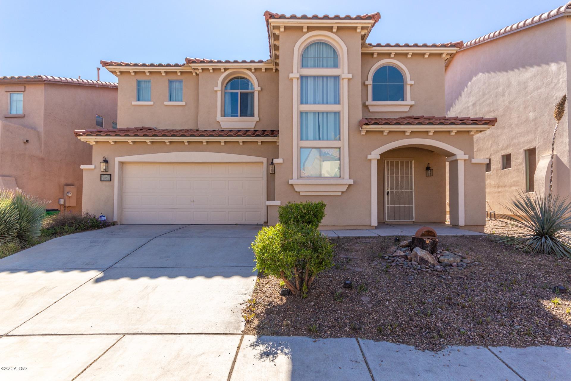 Gorgeous two story 3 bed/2.5 bath home with great curb appeal available in prestigious Rancho Sahuarita. Love life in this amazing lake community with beautiful parks, a pool and spa, athletic facilities, sports courts and more. Inside is immaculate. Impressive living and dining area features dramatic soaring ceilings, elegant pendant lighting and neutral paint tones. Wood floors in the living room and den. Inviting kitchen boasts plenty of cabinet and counter space, coordinating black appliances and a large pantry with a beautifully etched glass door. All bedrooms are upstairs, including the master with a private 3/4 en-suite. Low maintenance backyard offers a covered patio and is fully enclosed with block fencing, perfect for pets or play. This gem has it all. See it and make it yours.