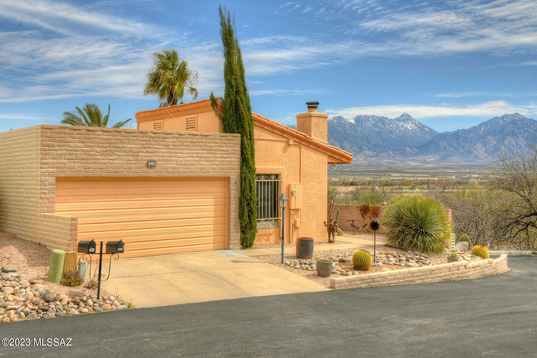 With it's gorgeous mountain VIEWS and a focus on outdoor living, this home is the perfect desert haven! The front of the house has loads of curb appeal with its lush desert landscaping, red tile roof accents and charming wrap around patio. Inside, the spacious living room is anchored by a corner beehive fireplace and features exposed beams lining the ceiling. Sliders from the dining area lead out to the red paved side patio, allowing an indoor/outdoor flow. The side patio wraps around to the back patio creating endless outdoor living space, and the MOUNTAIN VIEWS are front and center from every vantage point! An open and bright kitchen looks onto the dining area and features a cozy breakfast nook for casual mornings. Updates include bright white cabinets and gleaming stainless appliances, adding a modern touch to the home.  A huge laundry room doubles as a butlers pantry and has loads of storage! Your primary suite has access to the VIEWS and patio through glass sliders. The second bedroom is perfect for guests and boasts a beautifully updated bath. The third bedroom can accommodate guest overflow, or act as a second office, yoga studio or media room. The options for the space inside this home allow you to easily adapt it to fit the lifestyle you've been dreaming of. The stunning and spacious outdoor living spaces will complete that dream!