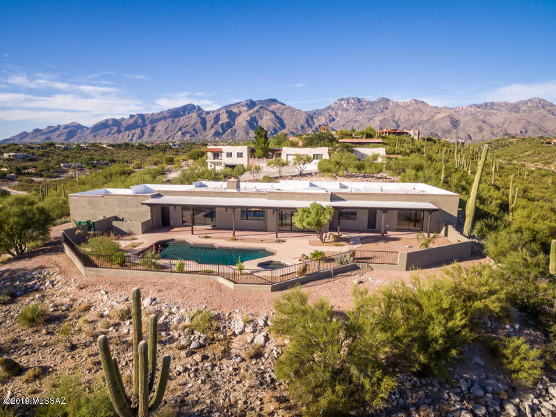 A completely renovated and re-designed foothills home with incredible views in 2018!  As you enter this gorgeous home you will love the beautiful contemporary style, with Canterra accents and Travertine floors throughout, beamed ceilings and custom shelving. Entertain in the chef's kitchen complete with a double oven & gorgeous granite countertops or spend a day enjoying the panoramic city views as you relax in the gorgeous pool and spa or covered patio. You will love the spa-like master bath and over-sized shower and master oasis that opens the backyard. New mechanical systems, pavered circular driveway, new cabinetry and appliances. Minutes from shopping and dining, this is truly a beautifully renovated home w/ spectacular views unique to the foothills.