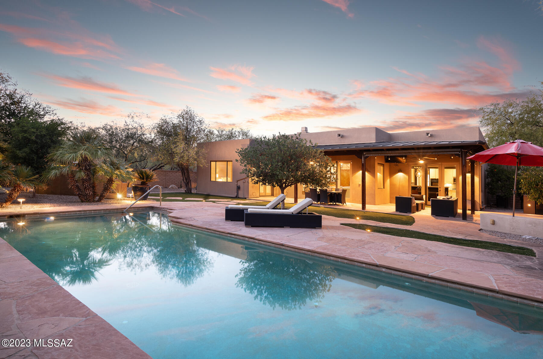 Rare opportunity to live in the coveted Parade Ground at Valley Ranch in the Old Ft. Lowell Historic District.  Enter thru a private gate w/ a canopy of mesquite trees to find a one-of-a-kind neighborhood w/ paver-lined streets & homes built around a grassy private park set against the picturesque backdrop of the Catalina Mountains.  This exceptional 2003 residence w/ 3 beds/3 baths + den is situated on a 1/3-acre corner lot across from the park. A covered entry w/ custom wrought iron doors leads to an interior space w/ high ceilings, an open floor plan, & abundant natural light pouring in. Experience the ease of living w/ this functional & modern space that seamlessly merges the indoor & outdoor space. The great room w/ a fireplace opens to the spacious kitchen w/ a center island,...