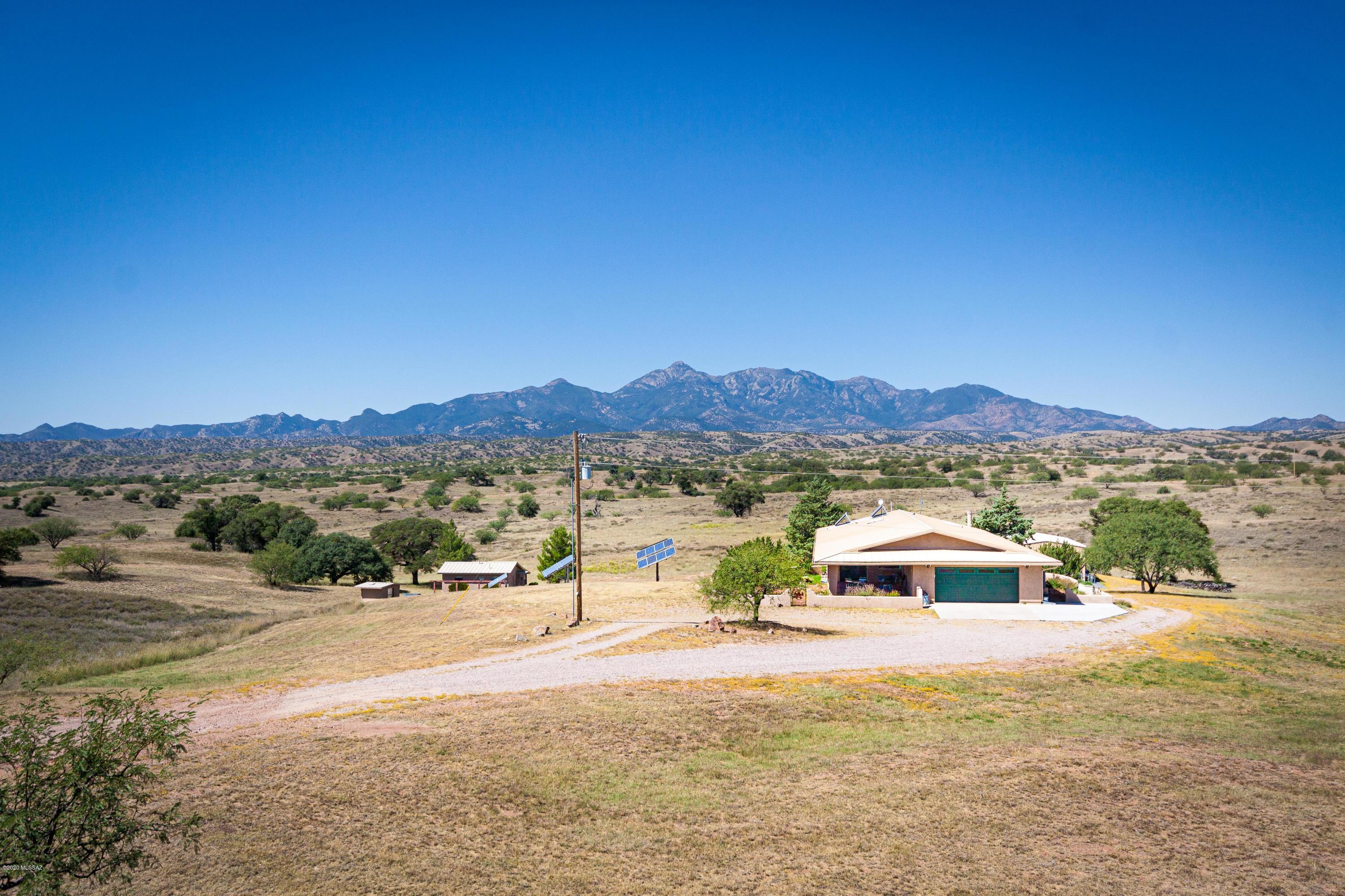 Escape to the peace and serenity of Sonoita in this elegant comfortable custom built energy efficient home. 
Bordering Crown C Ranch, Parklike rolling grasslands , dotted with oak trees and amazing views of Santa Rita Mts.
This spacious home has a newly remodeled chefs kitchen with large island, dining area & great room with a cozy fireplace and large sunroom with lots of windows looking into a lovely courtyard. Basement has living quarters and tons of storage. 
New 24x40 steel building, an outbuilding for more storage or can be made into guesthouse.
Partial Solar & private well.
More land is available.