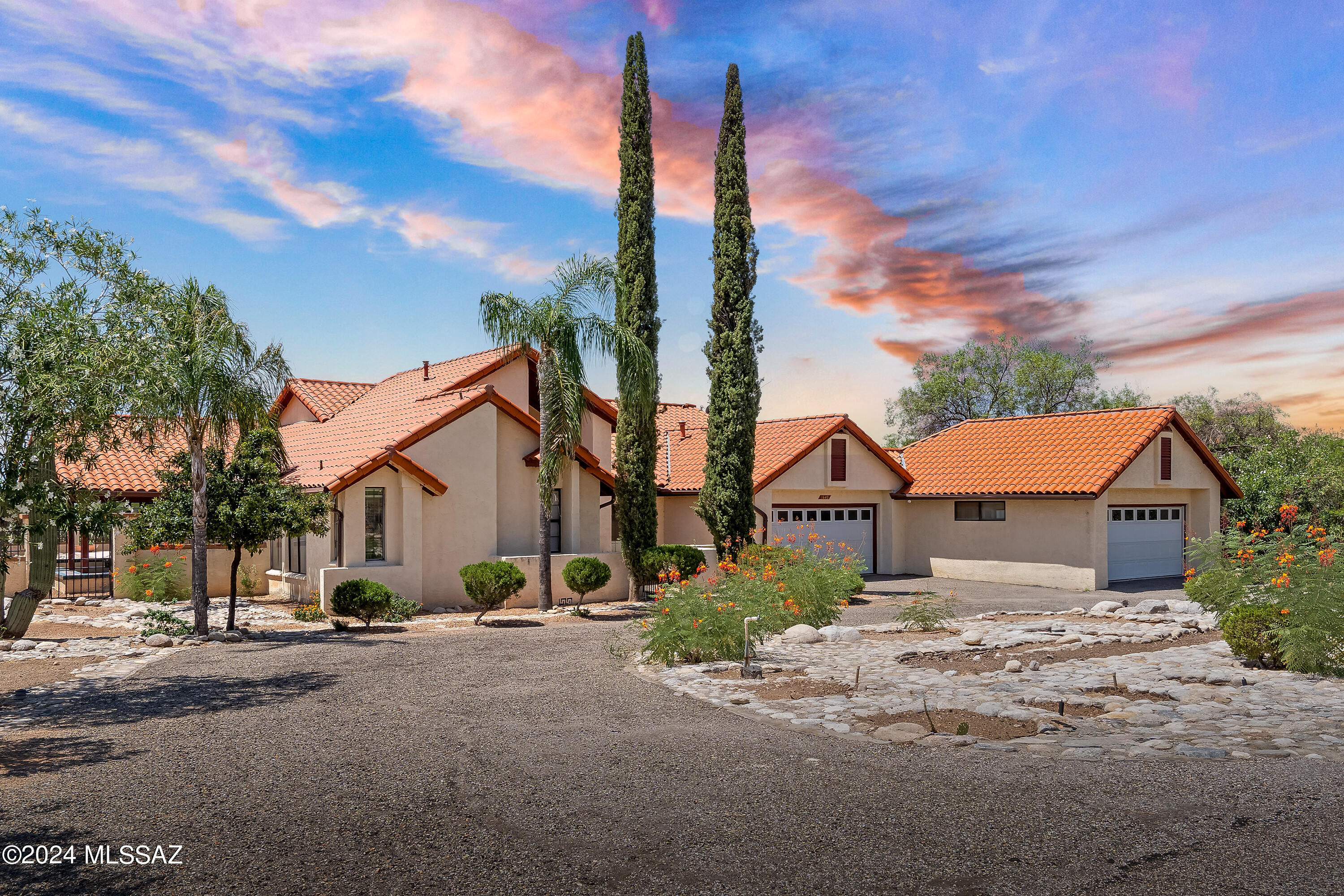 This sprawling Spanish Contemporary is situated on a 3/4 acre corner lot in the coveted Shadow Hills neighborhood. Vaulted ceilings throughout the living areas center around a fireplace and gracious kitchen with chef-worthy appliances and granite countertops. Two primary suits, two additional bedrooms, Four bathrooms, a Four car garage, wraparound arizona room, and pebble finish pool and spa complete this home. Located in district 16 schools and just a short drive to the University of Arizona, Banner Medical Center, and La Encantada.