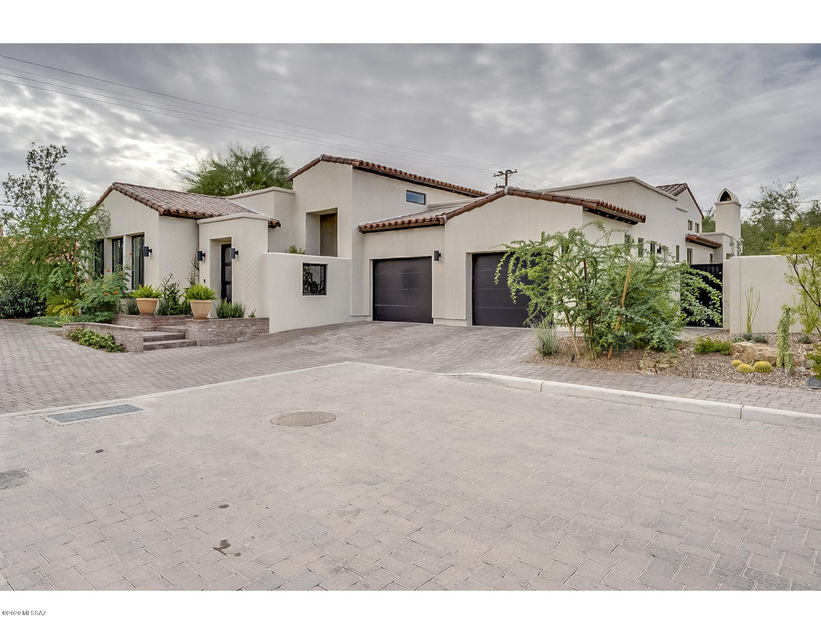 Rare opportunity to enjoy urban living in an private enclave near the famous AZ Inn.  This 3BR/3BA house exudes the style and quality sought by the most discerning buyers.  Exquisite finishes and upgrades surpass the imagination and include Italian tile floors, waterfall quartz island, gas fireplace, commercial grade appliances  and more.. This is a hidden gem close to Banner, UofA, downtown and the best that Tucson has to offer.