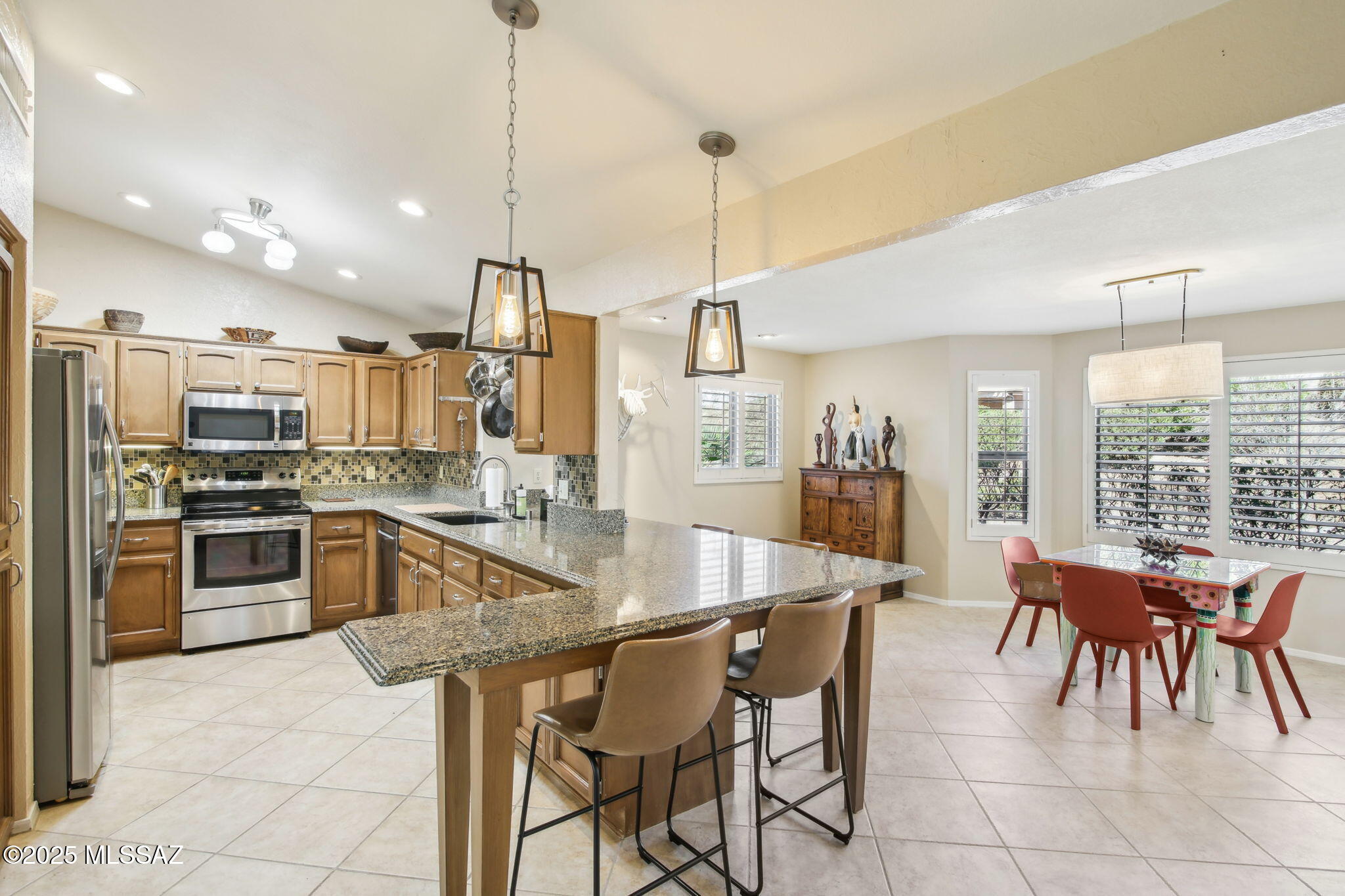 Expanded SONORA floor plan with added dining space and family room with mini-split. Relax in the backyard on the patio or in the hot tub, surrounded by shrubs and block wall for added privacy. Entertain in the great room with vaulted ceilings and cozy gas fireplace. Kitchen has granite counters with a peninsula breakfast bar which is open to the dining area. Expanded dining room has bay window with rose garden out back. Shutters on windows and no carpet - new LVP in primary bedroom. HVAC replaced in 2012. Extended garage - room for 2 cars and stack a golf cart. Epoxy driveway & garage floor. Water softener system. Front flagstone patio with a pony wall to enjoy morning coffee. Come enjoy SaddleBrooke - restaurants, pickleball, golf, arts and crafts! TURNKEY option - separate bill of sale.