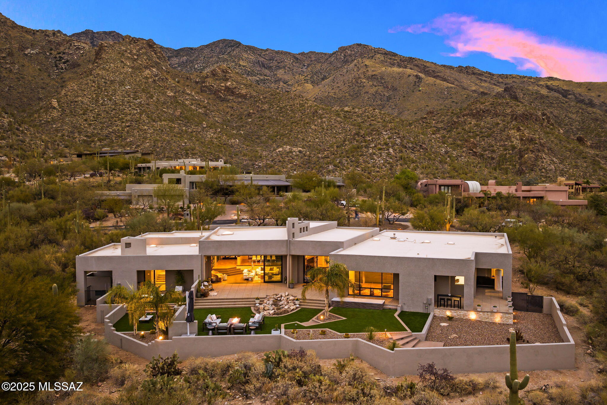 Stunning city views through walls of windows serve as the backdrop to this dramatic contemporary in prestigious guard gated community of Finisterra. This striking and sleek contemporary design seamlessly integrates functionality of floor plan with explosive city & mountain views from every room. No detail is spared throughout this dramatic floor plan including artistic custom wrought iron railings leading to sunken LR w/cherry built-in bookshelves & fireplace. Gourmet kitchen w/cherry cabinets, granite & top-of-the line appl. leads to large eat-in area w/cherry wood built-in buffet & wine refrig serving as the perfect space to entertain. Separate wing w/enormous rec room, 2 BR/2 BA, provides privacy for guests & family. This truly is the ultimate trophy view home in all of The Foothills!