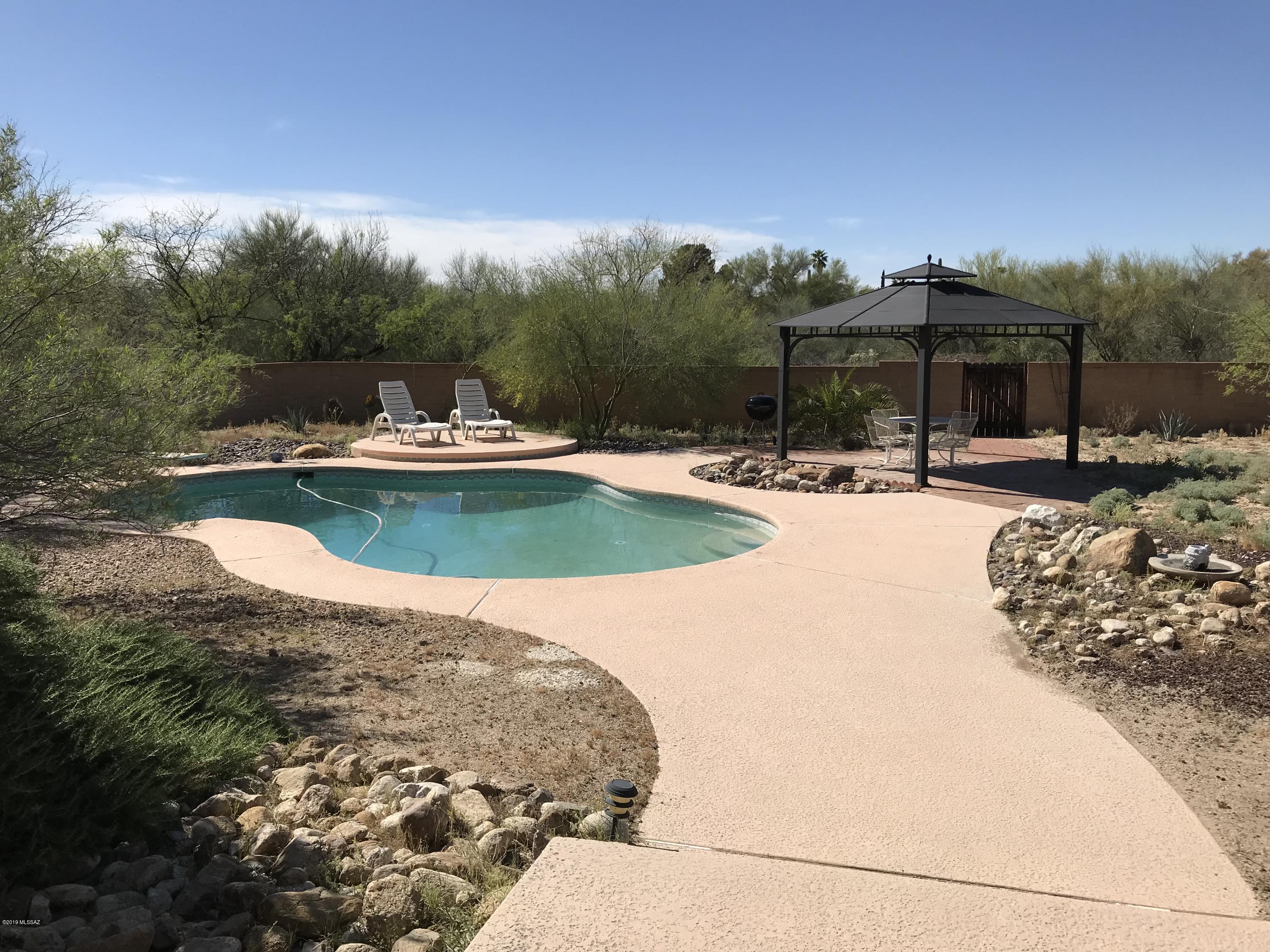 Lovely Ranch on over half an acre.  This home shows pride of ownership.   In addition to large living and family rooms there is a huge game room and a studio, both with extra storage.  The studio could be converted into a casita as it has seperate access.  Game room offers tons of natural light with five skylights that open for fresh air and that great indoor/outdoor feel.  The sparking pool and ramada are perfect for summer days and relaxing evenings. 18 inch neutral tile throughout, no carpet, indoor laundry, large walk in closet in master and RV pad in addition to attached two car garage. AND two newer HVAC units!
