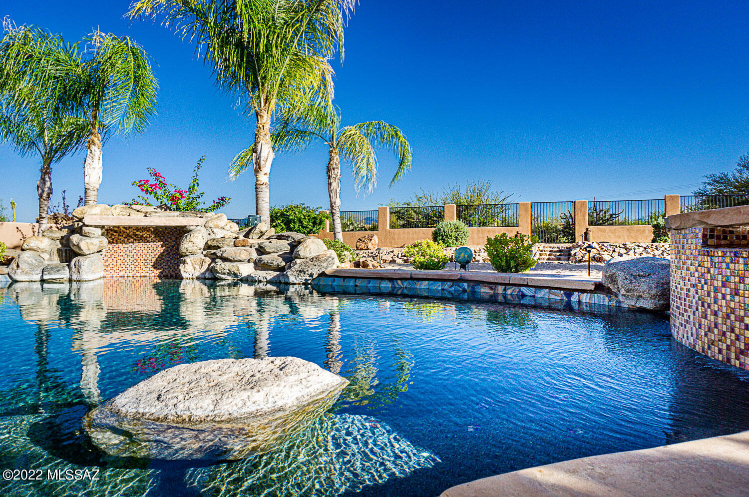 A REWARDING ESCAPE PEACEFULLY SITUATED! Modern and upgraded, this 4 bedroom, 2 bathroom + Den home with Sparkling Pool rests on nearly 1 acre lot with NO HOA in Mesquite Heights. With a flowing layout this beautiful home boasts a kitchen with Granite counters, subway backsplash, plenty of cabinetry, breakfast bar, breakfast nook and new stylish light fixtures. Light and bright Great room concept with plantation Shutters and Gas fireplace.  Formal dining area perfect for entertaining. Spacious master suite with fireplace, new carpet and new Pella French doors to access back patio. Master bath has been fully remodeled offering a Spa like walk-in shower, new lovely tub, new Quartz counters, new sinks & faucets, new Pella window and new tile flooring. Desirable Split bedroom floor plan provides privacy for family & guests. Additional 3 good size bedrooms and a versatile den that offers extra living space. Guest bath also with new Quartz counters, sinks, faucets and plumbing fixtures.  Relax in the resort style expansive backyard that offers StoneScapes Mini Pebbles Pool & Spa with LED multi color lights,  grass, Flagstone and  lovely Mountain views. Laundry room with utility sink and cabinetry. 3 car garage with epoxy flooring, storage cabinets, racks and new keypad. New fans throughout, fresh interior paint, Plantation shutters, new light fixtures throughout, new Nest Thermosets, Alarm system package with cameras and doorbell, smart irrigation control box, new non-solar screens, tile & laminate wood flooring and much more. You'll appreciate the short distance to Shopping Centers and easy access to I-19. A must see!