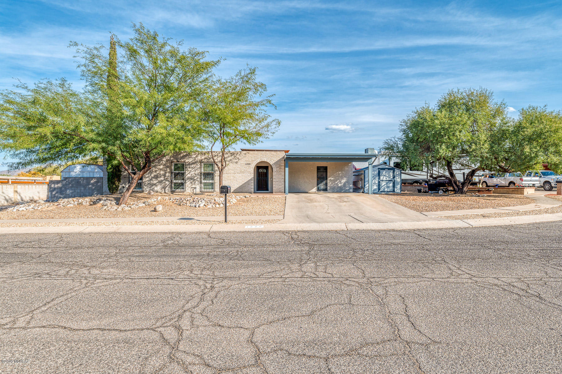 Pride of ownership is evident throughout this updated & move in ready 3 bedroom + den/office, 2 bath home w/ heated pebble tec pool & spa installed in 2020! The open floor plan has 2 living areas that complement the fully remodeled kitchen w/ breakfast bar & dining area. The generously sized laundry room, located off the 2 car carport, acts as mudroom with ample storage space. 2012 addition created beautiful owner's suite that includes walk-in closet, jetted tub, & large separate shower. 2 additional bedrooms w/ custom closet shelving, hall bathroom, and a den finish off the interior.  Den/office can become a 4th bedroom just by adding a door.  In addition to the pool & hot-tub, backyard has covered patio, artificial grass, and beautiful mountain views.
