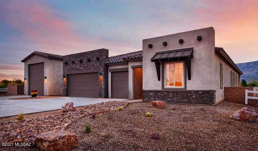 This ranch-style model home greets guests with a 3-car garage and inviting covered entry. Inside, you'll find airy 10' ceilings, 6'' x 48'' wood-look ceramic tile flooring and a great room with multi-slide doors leading onto a covered patio. You'll also appreciate a gourmet kitchen featuring quartz countertops, a center island, a walk-in pantry and matte black appliances. Other highlights include a central laundry, a lavish owner's suite with a tray ceiling, private retreat, walk-in closet and deluxe bath with barn door and walk-in rain shower, and a club room. A quiet study with French doors and a built-in bookcase and two secondary bedrooms with a shared bath complete the impressive home. Includes additional windows and a cabana with fireplace! Also included: a detached 50' RV garage!