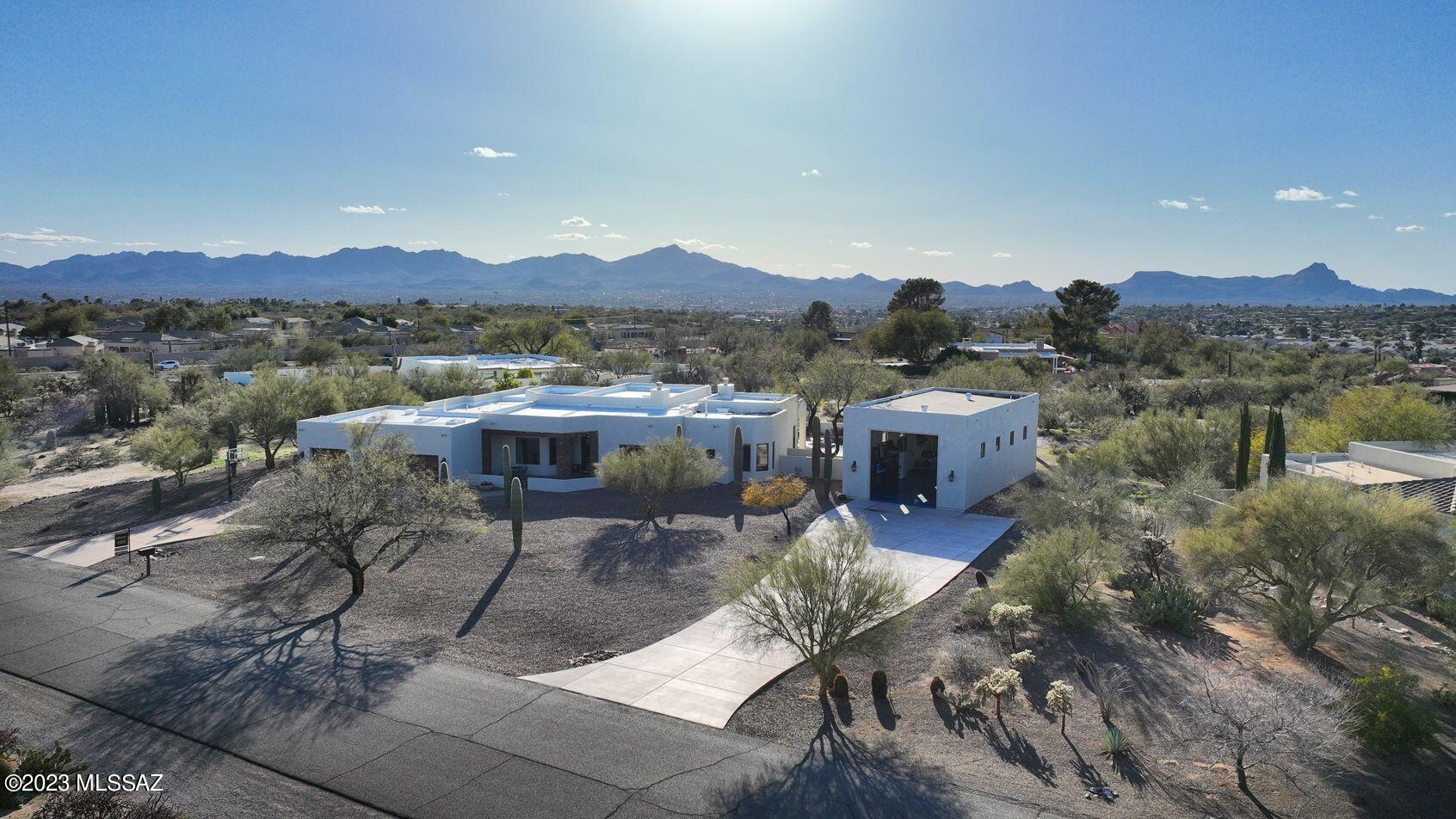 Gorgeous home in sought after Tuc Nat Est w/golf cart access to highly acclaimed Omni Tucson National Golf Resort. Guests are greeted by oversized French wrought iron doors. Home remodeled in 2021 with great attention to detail. Open concept living, hub of the home is flooded with natural light, floors feature oversized ceramic tile, with 12' ceiling throughout. Kitchen is a cooks dream: double ovens, 5 burner gas range w/fully vented hood. Quartzite Island features double sinks and storage galore! Enjoy cool evenings by the fireplace in both the great room & primary ensuite w/14' ceiling, tons of light, luxury bath with custom tile, over size soaking tub and expansive walk in California Closet. Covered patio's, built in grill, pool, large RV garage. Owner is licensed agent.