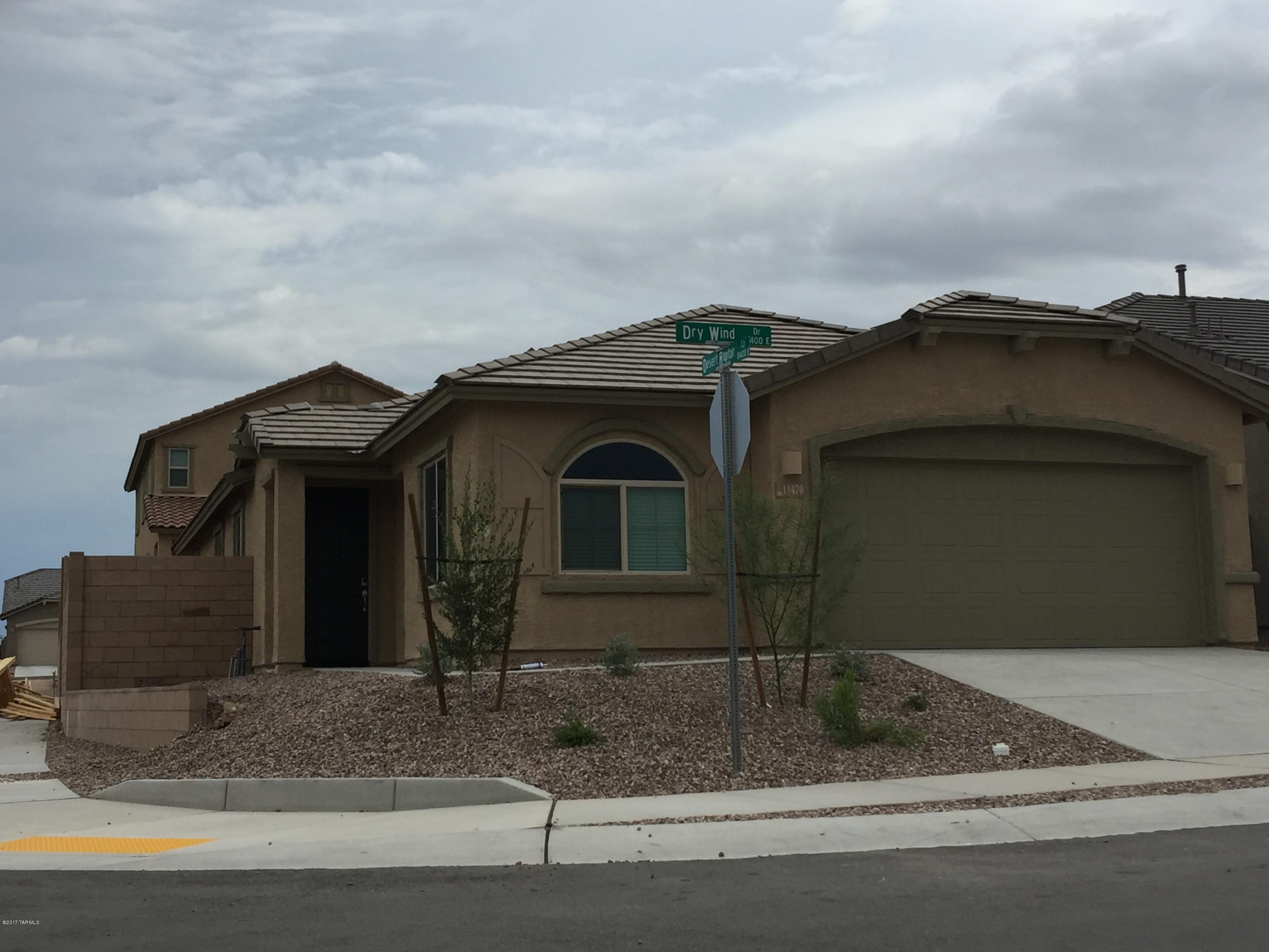11470 East Dry Wind Drive Tucson, AZ 85747. Brand new never lived in 4 bedroom 2 bath Lennar home on a corner lot. Out of state investor bought it as a rental house and here is your chance to be the 1st people to live in the house. Almost $25,000 in upgrades and options for your comfort. Super luxury flooring and bath package to include better sinks and faucets, thick pad, quality carpet, and 20 x 20 inch floor tiles. Ceiling Fans and lights in all the bedrooms. It also included a gourmet kitchen with stainless steel appliances, granite counter tops, and recessed lighting. House also has 10 foot ceilings for the open feeling. Refrigerator and window blinds are included.