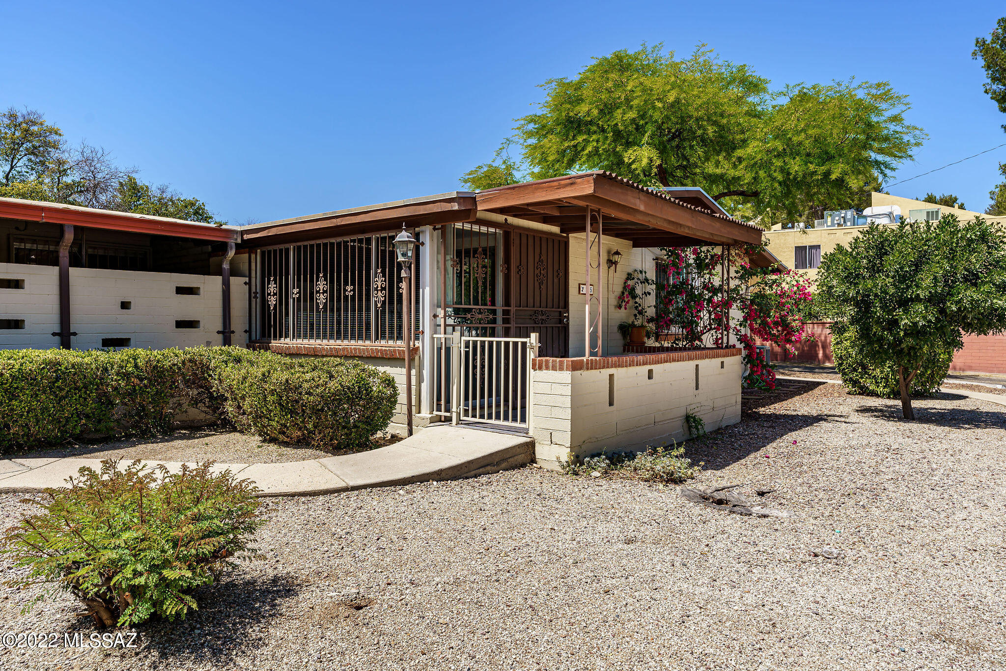 Very nice 2 bedroom, 2 bath 960 sq ft unit tucked away in the back of this East Tucson park-like complex.  Newer ceramic plank tile flooring throughout with some ceiling fans and skylights.  Kitchen has black appliances, granite counter tops with window at sink, and plenty of white cabinets with hallway pantry.  The extended living room is off the kitchen with a bonus room as well.  Nice size master bedroom, and family room has a corner gas fireplace.  This unit has a private laundry / storage room in back next to covered carport space.  Community pool area includes a ramada with outdoor grills. HOA covers pool, common area maintenance, trash, sewer, and water.  Easy access to public transportation. A Choice Home Warranty to 11/17/2024 is included.  Hurry, this one won't last!