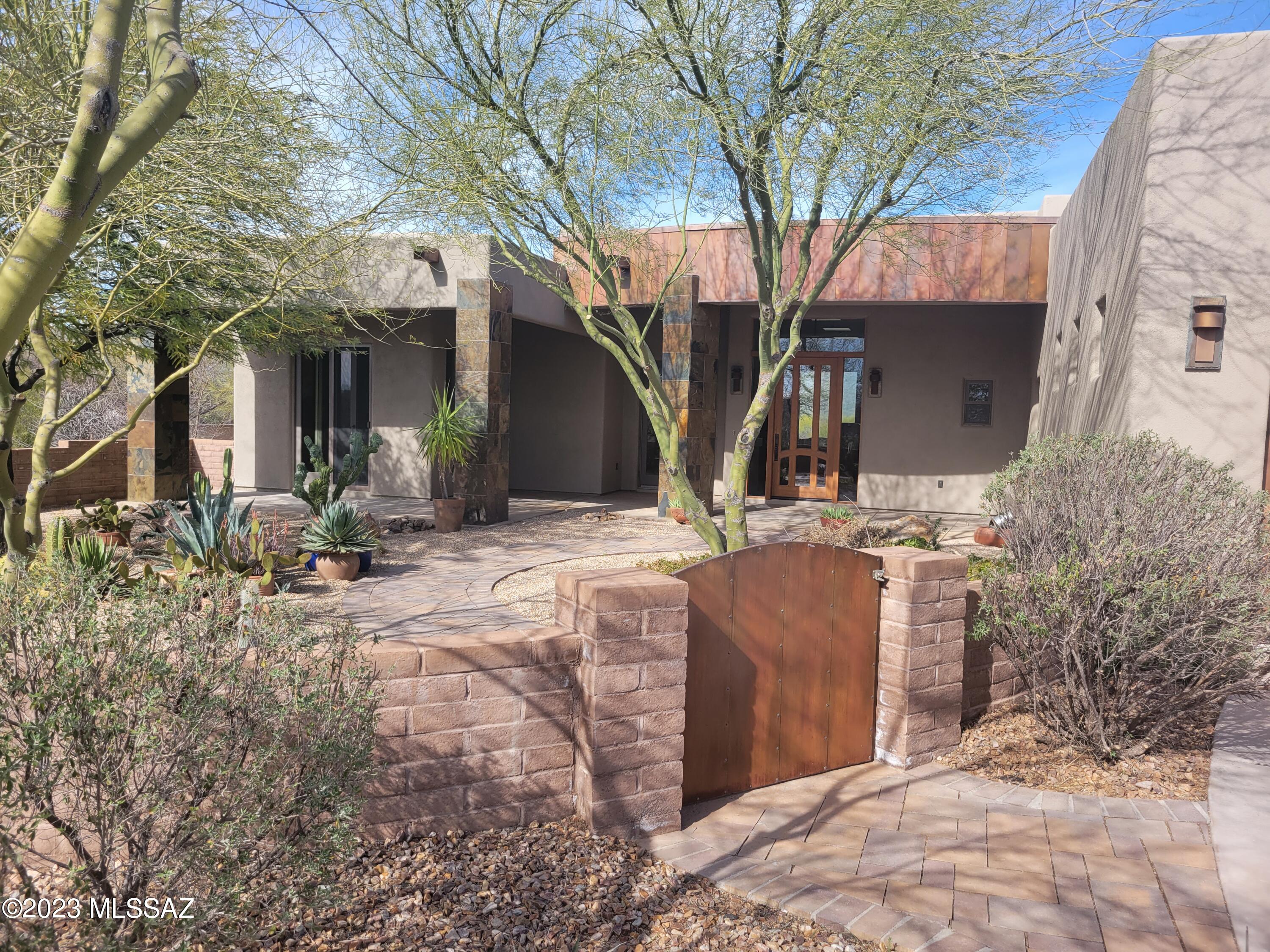 Beautiful single story contemporary home built in 2010 with gorgeous Rincon Mountain views.  Open concept living at it's finest with chef's kitchen, including butlers panty. Gas fireplace anchors the open living area where no space has been wasted. Home boasts split bedroom floor plan with guest suite or media room that can easily be the perfect design for multi-gen living or guests coming to swim in your pool!  Remaining 2 guest bedrooms are linked with Jack & Jill bathroom. MUST SEE!