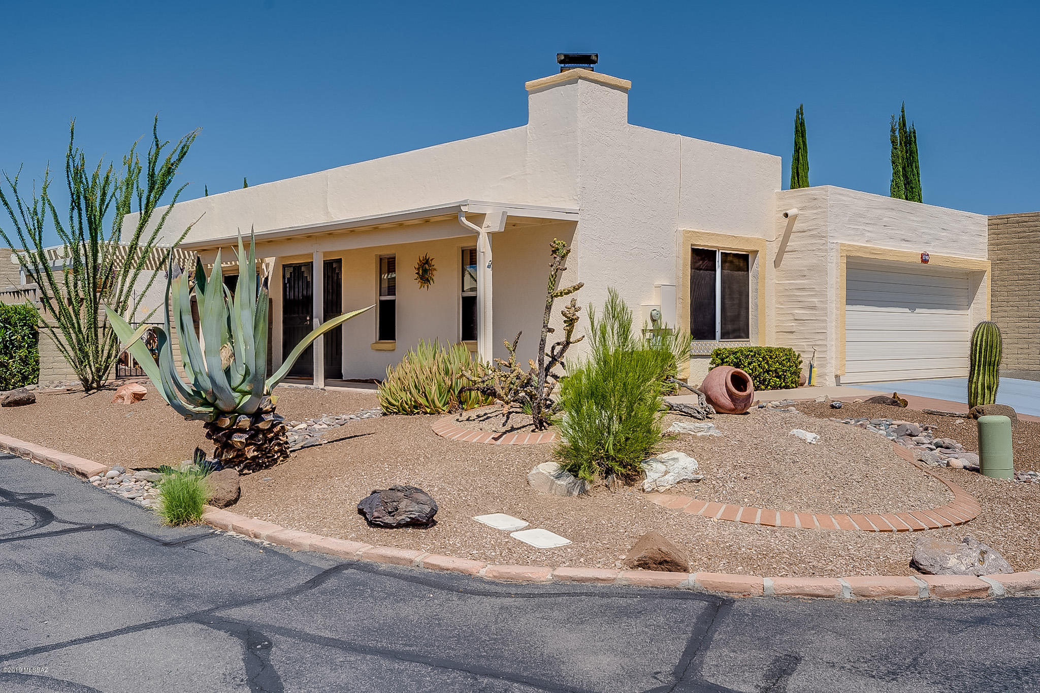 You will love stepping into a home that is Move-In Ready, meticulously cared for. Plus, full of upgrades and boasting an excellent mountain view while sitting in front of the beehive fireplace. Natural light streaming in from an atrium and skylights illuminates the freshly painted interior with new window treatments, perfectly placed accent walls and no popcorn ceilings. These colors compliment the tile floors throughout. Both bathrooms have new light and plumbing fixtures, water saver toilets and the Master Bath has a new tile walk-in shower. The added height to the wrap-around patio wall assures privacy while relaxing under the ramada gazing at Elephant Head. Exterior improvements include new paint, conversion of the screened porch to an Arizona room, installation  of an HOA approved 8x8 storage shed and a roof warranty.