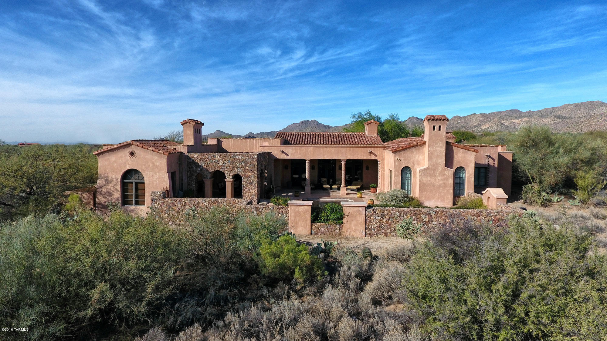 STUNNINGLY BEAUTIFUL TUSCAN VILLA BEING SOLD ON A TURN KEY BASIS! Upon entering through the stone courtyard and massive front door, you are transported to another place and time where vaulted ceilings, antique beams, over-sized brick pavers and a great room with chandeliers and French doors create a sense of rustic elegance and permanence rarely seen in homes today. The chef's kitchen opens to the great room and features high end appliances and a twelve foot center island while the master suite offers a seating area, fireplace and his & hers facilities. French doors in the master open to the covered patio, pool and stone pergola with dining area and fireplace. This example of authentic Tuscan architecture designed by Ron Robinette is a masterpiece that must bee seen to be appreciated.