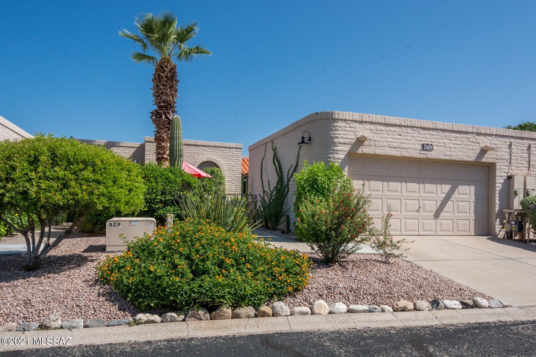 Absolute Gem with tremendous location! Gated courtyard welcomes you into this lovey townhome featuring a large living room with beehive fireplace with Talavera tile hearth and nice neutral tile in all the right places. Updated kitchen and bathrooms have hickory cabinets and Stilestone counters. Truly unique AZ room with sliding screens that allow you to close it off or open it up to the fresh air just by adjusting the screens. Oversized master suite has ensuite bath with walk-in shower. Nice guest bedroom and full bath. Multiple skylights keep this home light and bright. Fantastic location near St Philip's Plaza and Joesler Village cannot be beat. HOA covers water, sewer, trash, front landscaping and more, plus a community pool,  clubhouse and direct access to Riverwalk/The Loop!