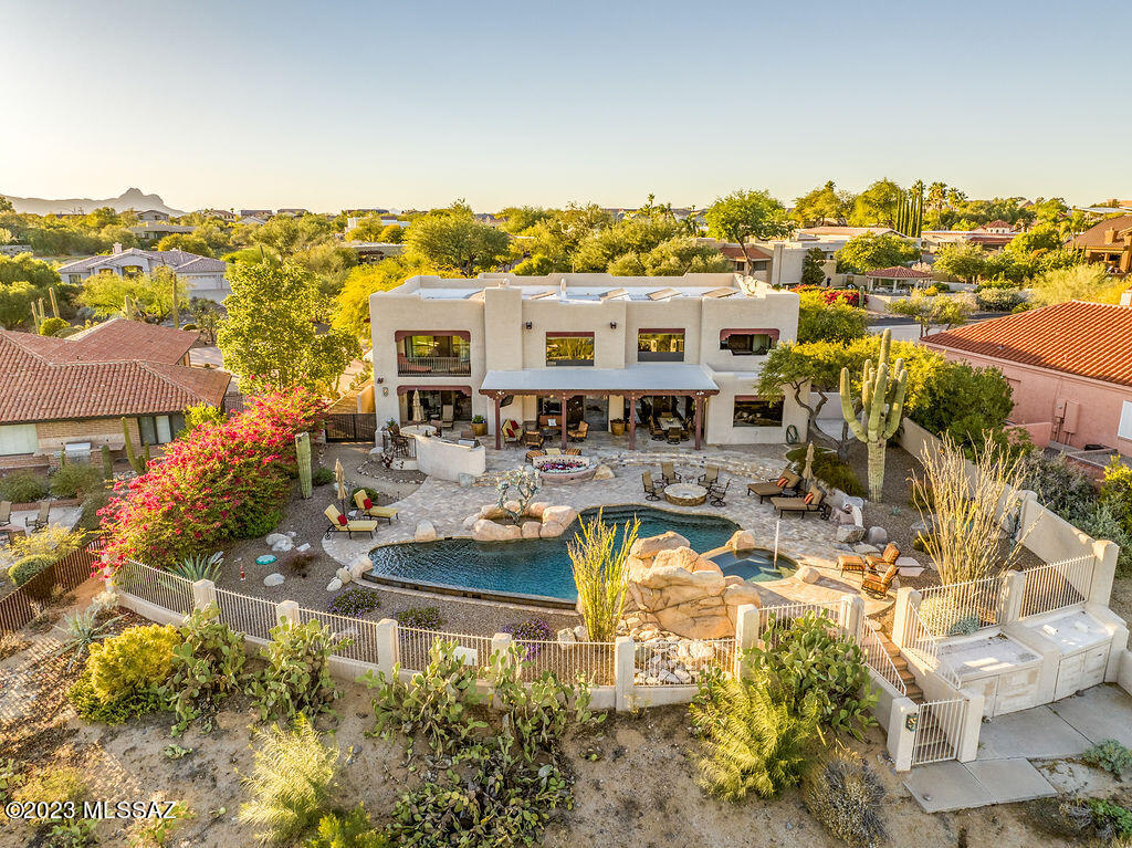 Perched on the side of a hill, with the MOST GORGEOUS mountain & golf course VIEWS, this 4527 s/f, 4 BD,3.5BA, WITH den AND office awaits that client that wants the ''WOW'' factor! Located w/i the gates of Tucson National, you will walk into a remodeled and enhanced home, with open great room & dining rm, gourmet kitchen w/Viking Stove & cooktop, den & office, then upstairs Master BD/BA with balcony, along w/3 guest rooms w/balconies. BUT...the ''piece de resistance'' is when you go through the Pella doors to the ''Backyard Paradise'' complete with new patios, outdoor kitchen, travertine tile thruout, lg pool/spa  w/built in slide, firepit, solar...  and THE BEST VIEWS Tuc Nat'l has to offer. Please check out the improvements in the document section. Come see for yourself!