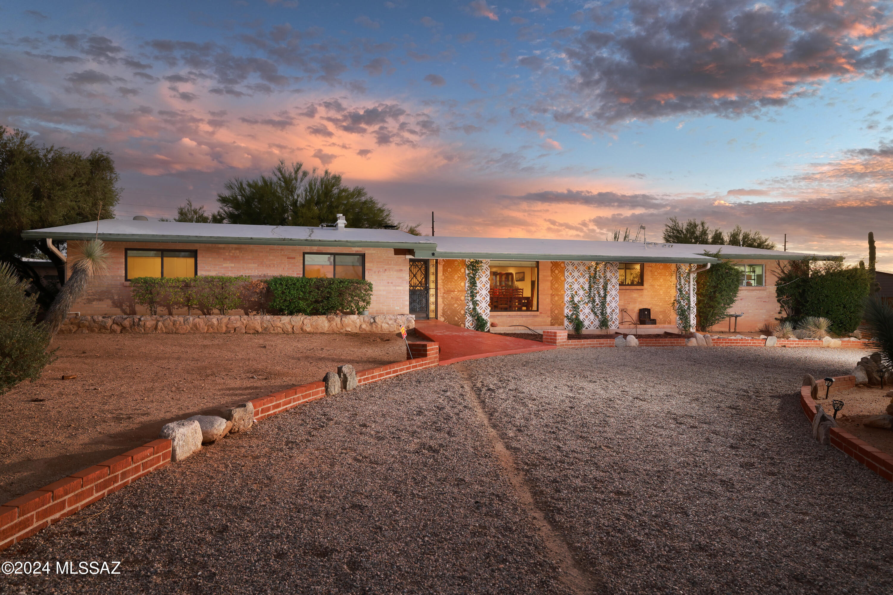 Welcome to 7220 N San Anna Dr., a beautifully updated property nestled in the desirable community of North Tucson. This stunning residence features a 3-bedroom, 3-bathroom main house and a separate, fully furnished studio guest house with its own bathroom, offering the perfect combination of space and privacy. Upon entering the main house, you are greeted by an open-concept living area, bathed in natural light from large windows that showcase stunning views of the surrounding landscape. The spacious kitchen is a chef's dream, boasting granite countertops, stainless steel appliances, and a large butcher block countertop island, perfect for meal prep and casual dining. The primary suite offers a tranquil retreat, complete with an en-suite bathroom and walk-in closet. The additional bedrooms are generously sized ensuring comfort for family and guests alike.
The separate, fully furnished studio guest house is a private haven, complete with a living area, bathroom, and kitchenette. This versatile space can be used for visiting guests, as an in-law suite, or leveraged as an Airbnb or long-term rental, providing potential additional income for future homeowners.
Step outside to your private backyard oasis, featuring a covered patio, lush landscaping, and a sparkling pool. For those extra hot summer days, the backyard is equipped with a misting system, offering a refreshing way to stay cool while enjoying the outdoors.
Located just minutes from shopping, dining, and outdoor recreation, this home combines convenience with serene living. Don't miss your chance to own this incredible property!