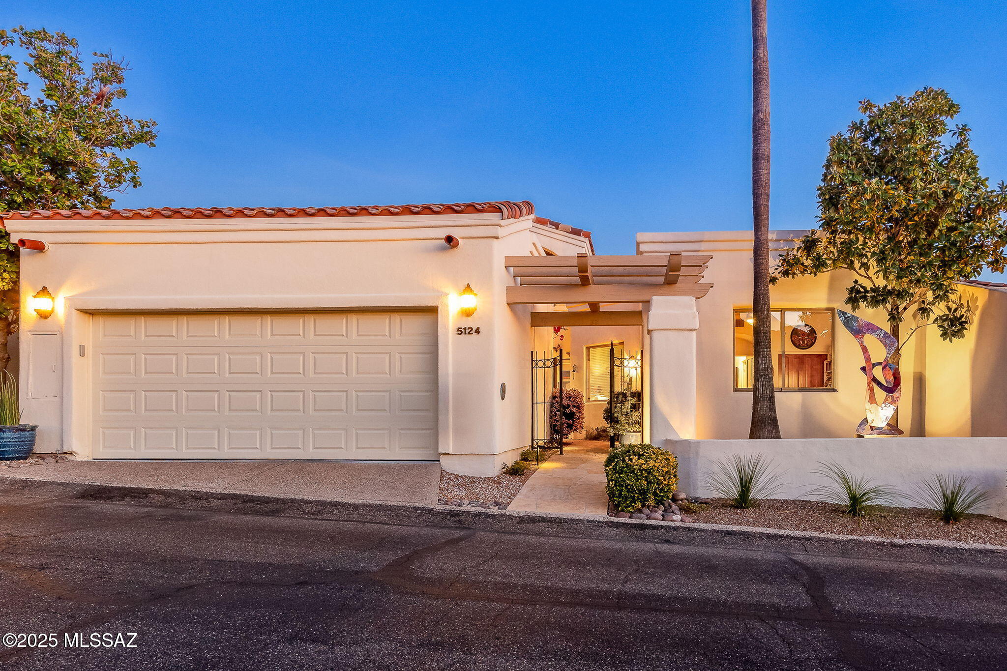 Nestled at the base of the Catalina Mountains in one of Tucson's most prestigious neighborhoods, this exquisite El Diamante townhome offers unparalleled artistic style and class. Located on the serene and picturesque Calle Brillante (the most beautiful street in all of Tucson), in the heart of the Foothills, within the guard-gated Skyline Country Club, this home is ideal for those looking to downsize without compromising on luxury appointments and amenities. Recently remodeled by an artist from Santa Fe, the home blends modern elegance with a tasteful artistic flair. The gourmet kitchen features sleek quartz countertops, new stainless-steel appliances, and ample storage, perfect for culinary enthusiasts. Two beautifully renovated bathrooms and fresh interior paint throughout provide a crisp, modern feel. The split floorplan (with NO interior steps!) ensures privacy, with the oversized primary bedroom boasting a large view window that frames breathtaking vistas of the lush private canyon, golf course, and city lights below. The inviting living room showcases a gas fireplace and a stunning wall of windows that overlook a lush green belt, providing an idyllic
setting for relaxation and entertainment. An art display wall creates the perfect backdrop to showcase your personal treasures. The open-concept dining area adjacent to the kitchen offers
a custom built-in buffet, floating display shelf, and ample space for both intimate dinners and large gatherings. Just a short stroll up the pathway at the top of Calle Brillante leads you to the
Skyline Country Club clubhouse, where you can enjoy some of the best city views in Tucson. Club amenities include a recently renovated Private Golf Course, golf Pro shop, tennis and pickleball courts, and a private heated lap pool. While membership is required to enjoy the full range of club benefits, ownership of this townhome provides access to golf and dining on a restricted basis. Come experience the lifestyle that only the Foothills can offer!