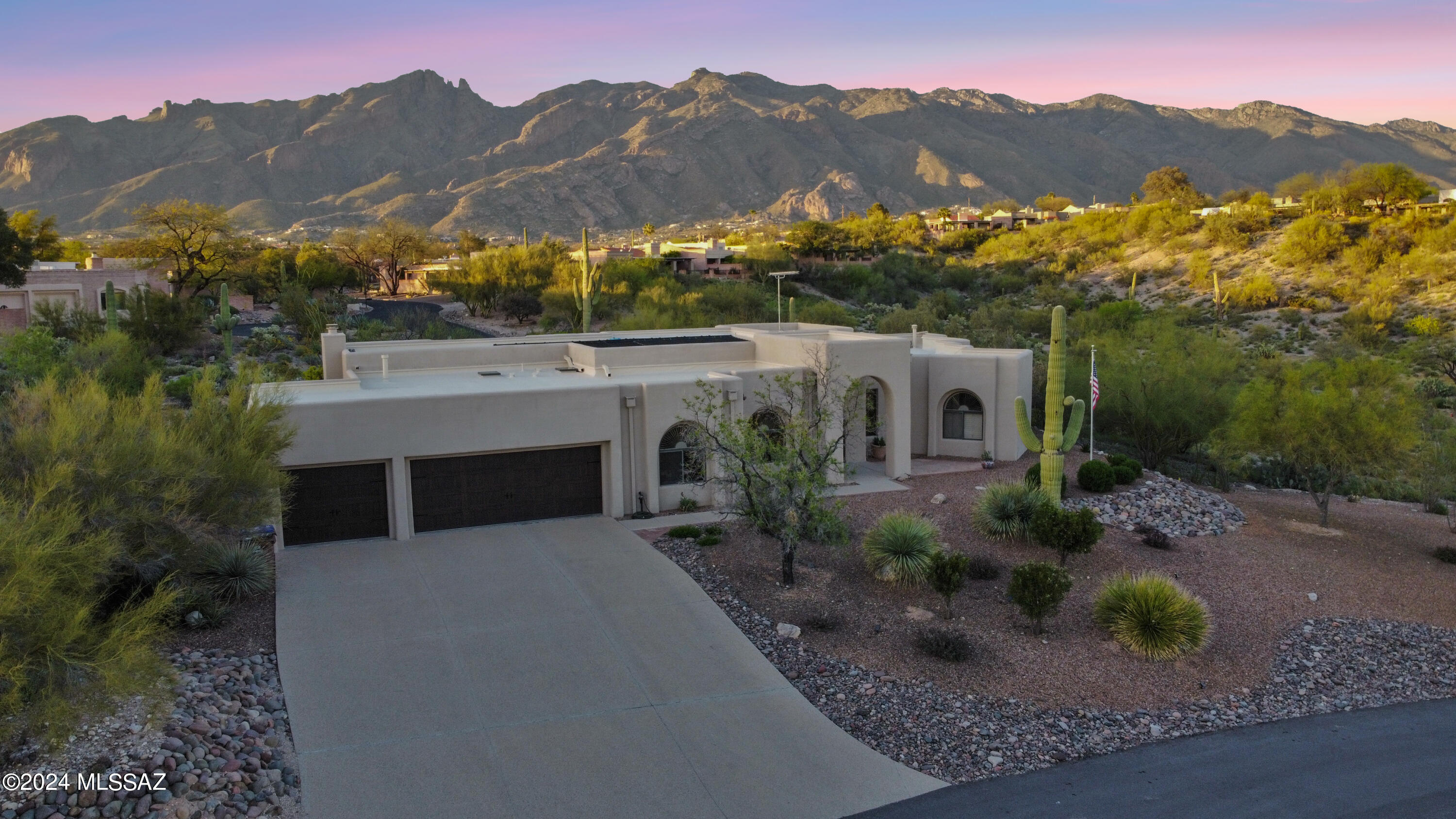 Range pricing:1,000,000.- 1,100,000 Luxurious Contemporary Retreat in the beautiful Catalina Foothills: Nestled atop a serene cul-de-sac, this stunning hillside residence offers true Arizona living with unparalleled mountain vistas. Crafted for both elegance and functionality, the interior boasts a seamless layout allowing for abundant natural light and captivating views of the Catalina Mountains from the family room, kitchen, dining area, master suite, and bath. Revel in the ambiance of lofty 10-foot ceilings, gleaming ceramic wood floors, and plush carpeting in all the bedrooms. Recently refreshed with a coat of paint, the residence exudes a sense of timeless appeal.  The heart of the home, a gourmet kitchen, features granite countertops, top-of-the-line stainless steel appliances, an expansive island,and a breakfast bar. An inviting family room offers a cozy fireplace and panoramic mountain views, while the master suite pampers you with an updated bathroom showcasing double vanities, honed granite countertops, and a luxurious custom shower with river rock flooring and dual shower heads. Additionally, the oversized custom master closet ensures ample storage.  Accommodations include three additional bedrooms, one featuring a queen-sized Murphy bed, and two full baths, all adorned with wooden shutters. Outdoors, the backyard oasis beckons with a solar and gas-heated Pebble Tec pool, a soothing waterfall, and a charming ramadaall set against a backdrop of breathtaking Finger Rock and Catalina Mountain vistas. Completing this exceptional property is a three-car divided garage with a separate temperature-moderated storage room. Experience the epitome of foothills living in this meticulously landscaped sanctuary.