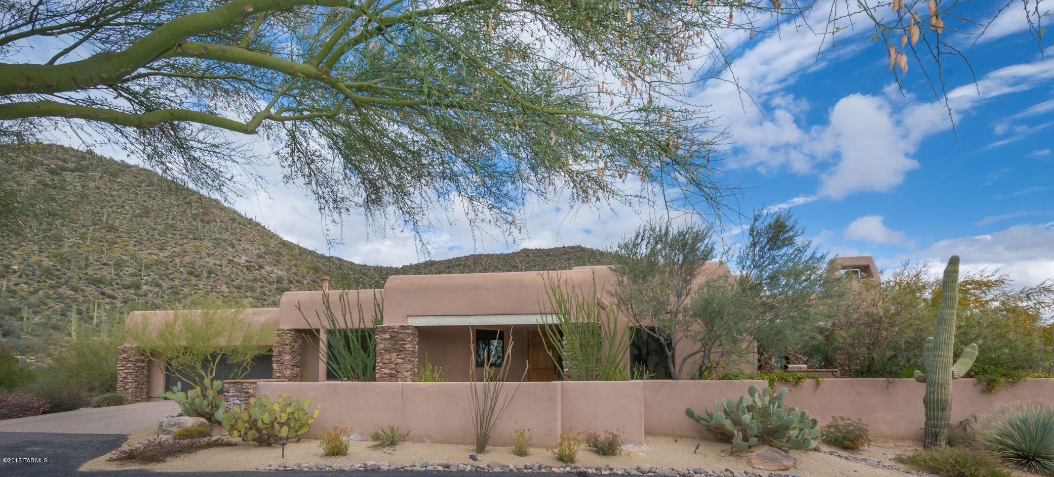 FURNISHED end unit Cottage at the Gallery in Dove Mountain offers 3BD/3BA in a gated community. 18X18 porcelain tile & upgraded carpet. Kitchen boasts maple cabinets w/pullout shelves, DBL oven & GE Profile appliances, granite counters. In-kitchen dining w/majestic mountain views, kitchen breakfast bar & desk. Laundry RM off kitchen w/wash basin & maple cabinets. Extended dining area & great room has wet bar/wine frig w/stacked stone frpl & wood beam ceiling that leads to an entertainers delight spacious covered outdoor patio w/frpl & BBQ.  Master suite w/built-in cabinets & FRPL. Dual sinks, oversized shower, travertine floors, built-in organized closets. 2nd bdrm/ba. w/travertine. 3rd. bdrm has built-in office & shares separate view patio w/ 2nd bdrm. HOTTUB !