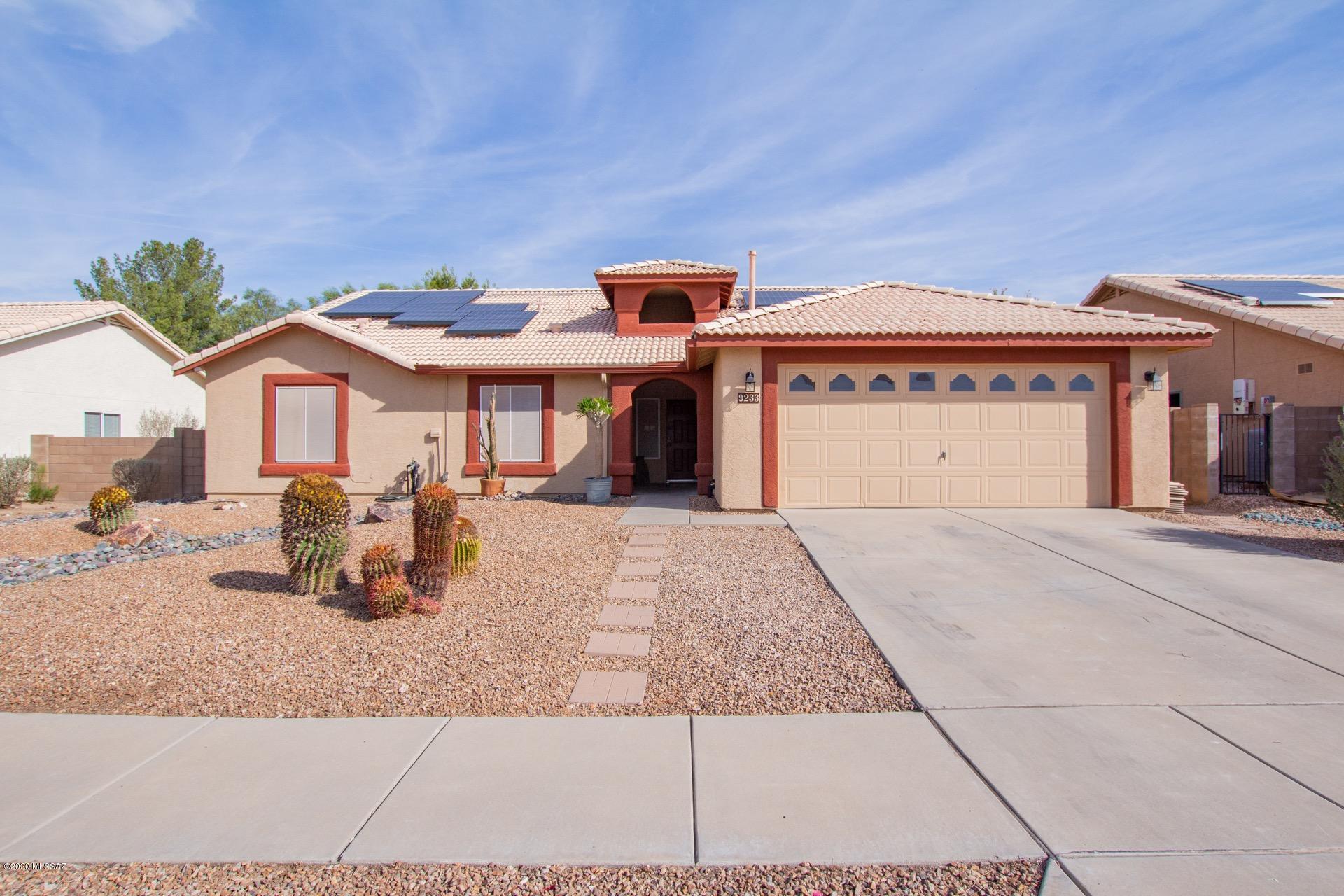Fantastic Energy Efficient Solar Home w/great curb appeal, 2 car garage, & sun screens. Soaring ceilings, custom palette, handsome luxury Vinyl Planking, ceiling fan, Gas fireplace for those chilly AZ evenings, & formal dining area w/patio access.  The family room is perfect for entertaining. Granite kitchen counters, breakfast bar, , pantry, & plenty of wood cabinets. 4 Generous sized bedrooms, carpet, ample closets, 2 pristine baths, & interior laundry closet. Enjoy the pool, hot tub, extended covered patio, & synthetic turf play area. Take a tour today!