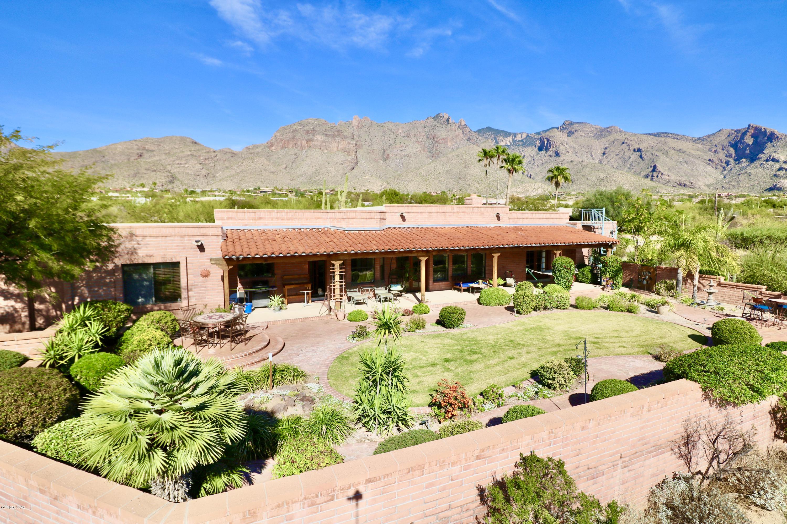 Unbeatable location! Beautiful & meticulously maintained custom built home in The Foothills Community!  Enjoy stunning panoramic City and Mountain views. Upscale features all around in this 3,205 sq ft home. Features include french doors throughout, large laundry room, high ceilings, travertine floors, huge storage room, and a great floor plan! Guest quarters/den/4th bedroom has a separate entrance- great for multi-generational living! Huge garage has connected workshop. Enclosed backyard has beautiful vegetation that is maintained by irrigation system.  Newer AC, water heater and roof, which was replaced in 2015 and re-coated in 2018. Unbeatable location being walking distance to La Encantada-Tucson's best shopping & restaurants!