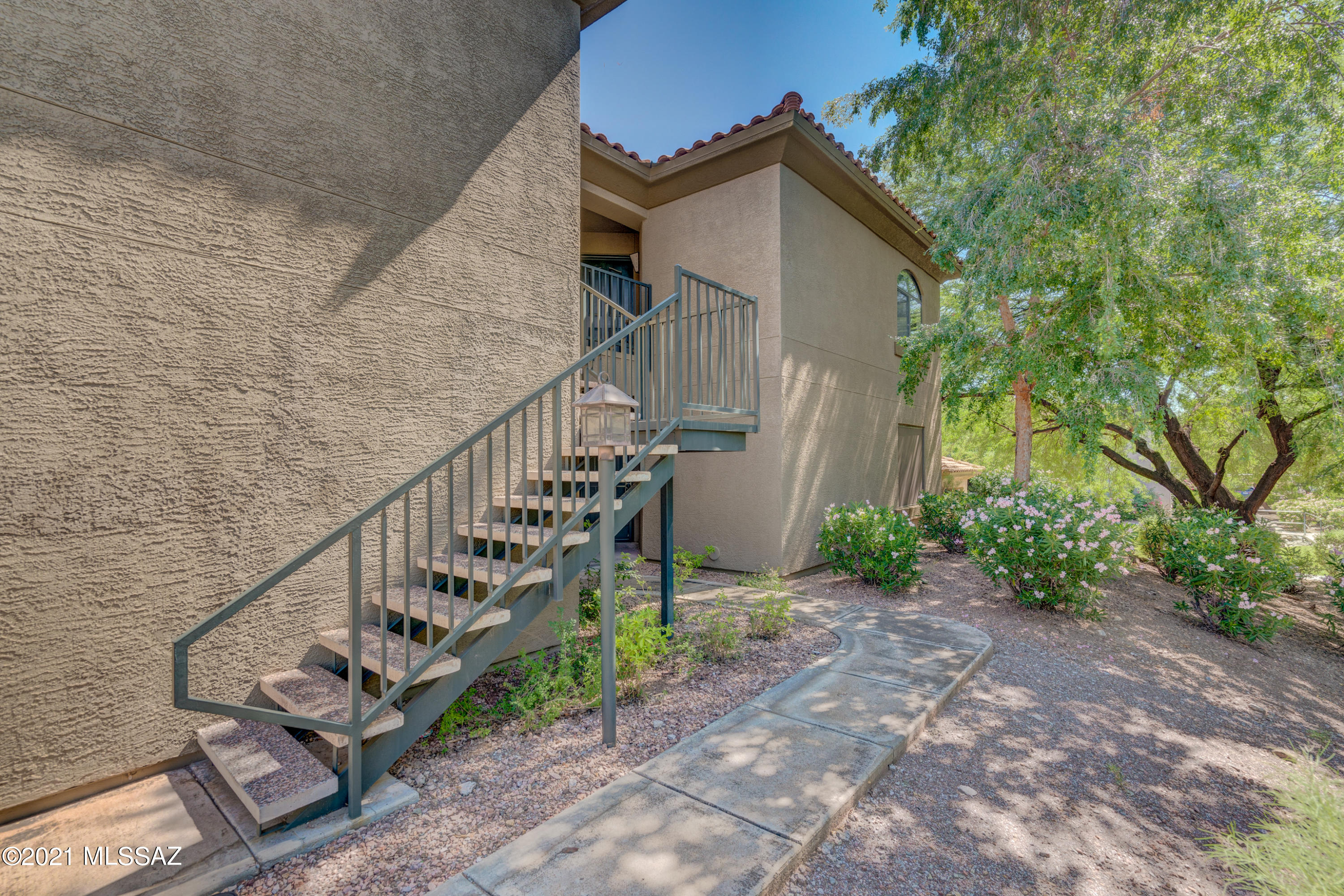 New carpet, flooring and paint! Move right into this gated 2 bedroom, 2 bathroom, 2nd floor condo, surrounded by the gorgeous Catalina Mountains. Bright kitchen with built in microwave and breakfast bar. Enjoy the split floor plan and spacious master suite with bathroom and walk in closet, plus slider to your private balcony with storage closet. Guest bath with lots of counter space and washer and dryer in this unit. Relax with all the amenities that include a fitness room, pool, jacuzzi, playground and BBQ areas with covered seating. Walking distance to great restaurants, shopping and more. Located in The Award Winning District 16