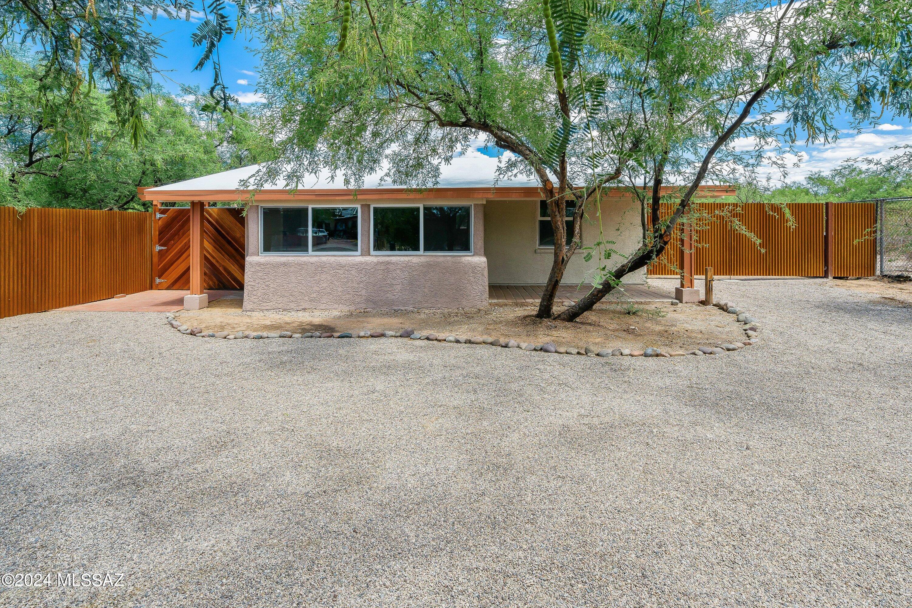 Beautifully renovated 1948 bungalow in the heart of central Tucson, boasting over 800 sq ft of stylish living space. Every inch of this home has been thoughtfully upgraded. Gleaming refinished Saltillo floors are a true highlight of the home's unique character. Essential upgrades include a brand new roof, water heater, furnace & mini-splits, ensuring year-round comfort & peace of mind. Kitchen features soft-close doors & drawers, under-cabinet lighting & SS appl. Bathroom offers a split design, w/ separate vanity area & an isolated toilet & bathtub for convenience & privacy. Spacious laundry rm provides ample space for addt'l storage. Situated on almost 1/4 acre, the back yard extends beyond the stucco wall & the gated yard is perfect for your pets. Circular driveway, large double gate.