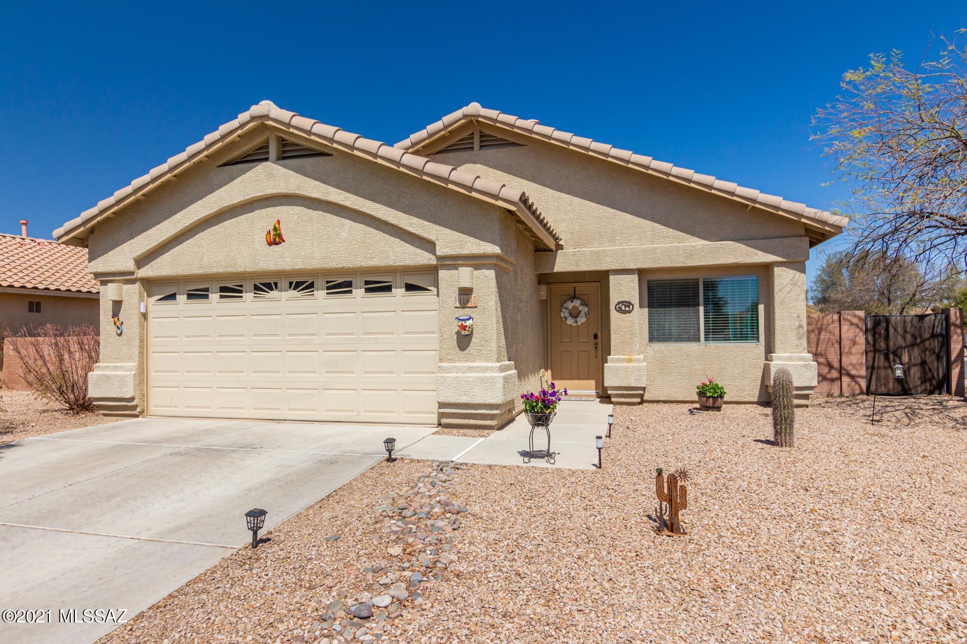 Fantastic single level home on a premium corner lot with view fence to open space behind. Sparkling pebble tec pool w/a waterfall, covered patio, & endless blue skies. Formal living room, plush carpet, soothing palette, window blinds, & upgraded lighting. Family room w/a neutral tile floor, ceiling fans, & patio access. Stylish kitchen features SS appliances, pantry & plenty of wood cabinets w/hardware. This meticulous home also features ample closet space, NEST Thermostat, Phone controlled lock system on front door, and non-pottable irrigation system (paid by HOA). Rancho Marana is conveniently located nearby Marana Town Hall, Splash Park, Community Parks, Rodeo Grounds, biking loop & more. Just 10 minutes from Tucson Premium Outlets. Don't miss this one!
