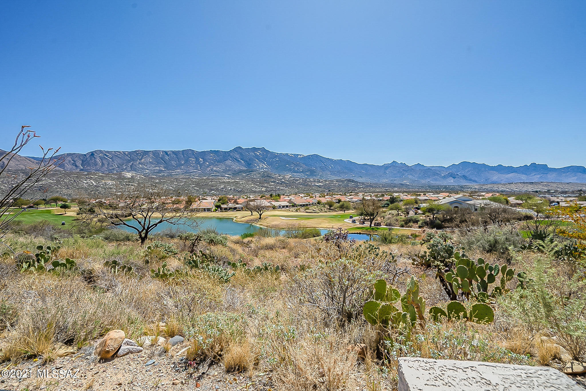 One of the finest VIEW lots in SaddleBrooke.  Elegantly appointed 3-bedroom & 2 ½ bath Cambria model sits on a high ridge overlooking #4 hole of Tucson course with spectacular, south facing PANORAMIC GOLF COURSE, LAKE AND SWEEPING MOUNTAIN VIEWS! Attached Guest House with private entrance & its own patio. Gated front courtyard offers privacy & enhances curb appeal. Home boasts formal & informal living & dining areas.  Private Den with built-ins. Gas FP in Living Room.  Open Kitchen has expansive breakfast bar & Nook with adjoining Family Room.  Luxurious Owner's Suite with sitting area features large view windows & opens to covered & extended bi-level flagstone patios.  Vaulted ceilings compliment the spacious rooms.  Large Laundry/Hobby Room. Extended 2 car garage & golf cart garage.