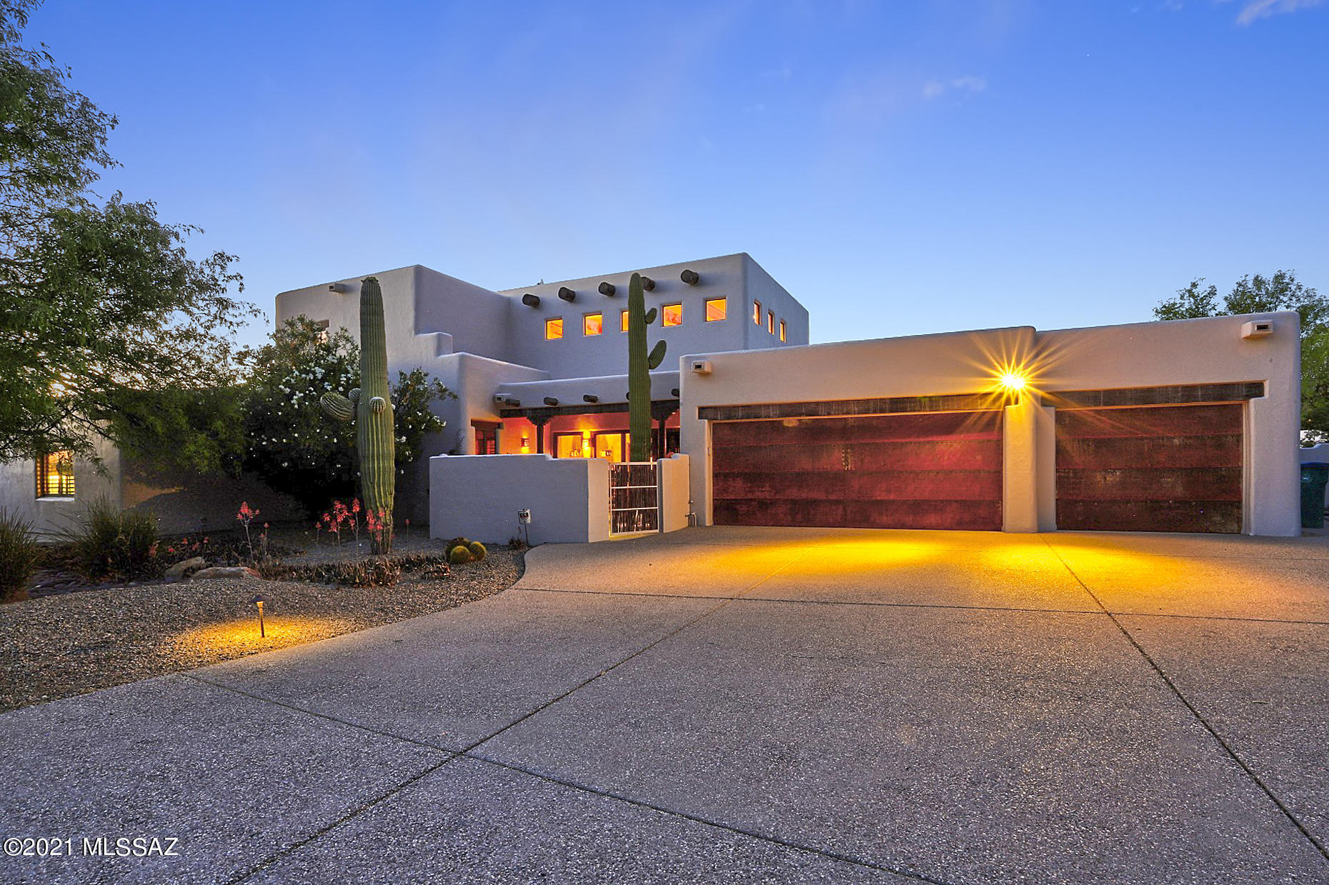 From the moment you enter the courtyard & walk through the front door of this amazing home, it's evident that every detail was thoughtfully considered.  As you take in the soaring ceilings, fireplace, and  massive beams of the great room you'll gaze through the expansive windows across the resort style rear yard & sparkling pool to the stunning Catalina mountains. Continue into the gourmet kitchen with an abundance  of storage of locally made custom wood cabinets which are throughout the house in the office, media rm & Family RM.  Enter the master retreat & into your personal spa bathroom to relax in front of the FP.  Up the spiral stairs is the lge guest suite w/ FP & spa bath. 2 other BR & bath are on the main floor.  Head outside to cook up something delicious at the outdoor kitchen, make smores at at the fireplace, or relax in the hot tub & watch your favorite TV show.  Kick back & Enjoy the privacy, peace & quiet. This is Tucson lifestyle at it's finest.  Make it yours today!