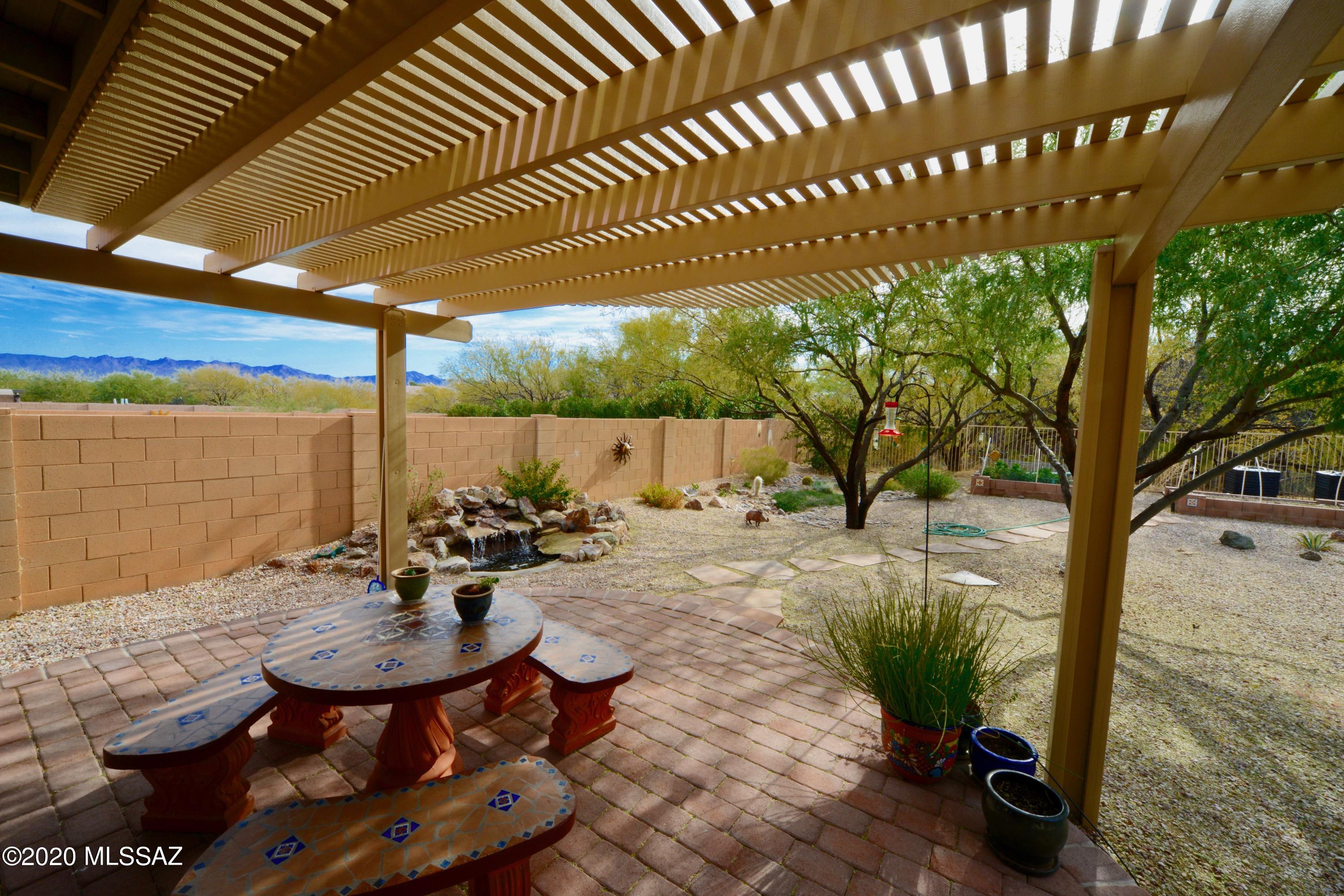 Looking for privacy or a bird sanctuary? This home is the one! Relax to the sound of water, in total privacy, while watching the birds play. Stunning landscaped backyard includes a water feature, pergola with birds of all kinds. You even have a bit of a mountain view from the back sitting area. The home backs up to open lush, yes I said lush, mature trees and wash. Serene yard with a park like feel, immediately outside from the kitchen. 
Inside, you will love the super clean interior with 4 beds, 3 baths + a loft. Enjoy 2 living areas plus 1 bedroom on the main level. Granite, alder wood with pull outs and SS in the kitchen with all appliance being less then 5 years old. HVAC is from 2015 too. This amazing home and incredible yard will make the entire family happy.