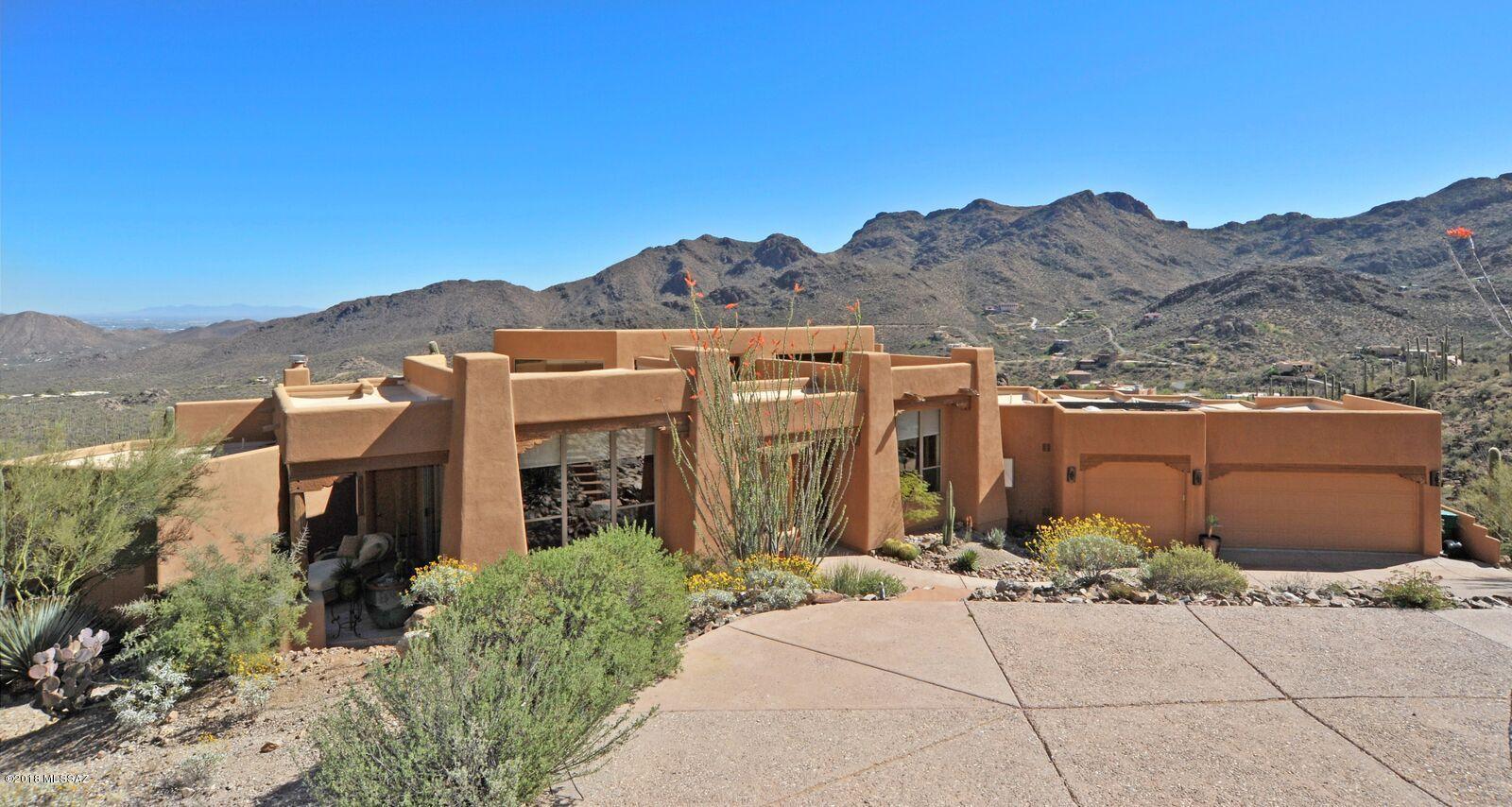 Enter & Say ''WOW'' as you Soak up the Mountains from EVERY ROOM in this Sensational, Stunning Home. Peaceful, Tranquil and Completely Private (no Need for Window Covers), this Beauty is Nestled IN Tucson Mountain Park Mountains...Surrounded by Over 1000 Cacti. Back Yard Offers End to End Flagstone Covered Patio & More Privacy. Turn to the Right to Watch the Sunset. Turn left and Watch the City Lights Twinkle. The Den/Office can be a Guest Room with it's own Bathroom/Shower & Private Patio. The Kitchen Offers a Six Burner Gas Cook Top, Stainless Double Ovens 
& Alder Wood Cabinets. Master Bedroom Boasts a Sitting Area, Dual Fireplace, His/Hers Closets, Walk in Shower & Jacuzzi Tub. It's Been a Second Home Most Of its Life..Looks/Feels Brand New. A Home Like This is Rarely Available. Enjoy