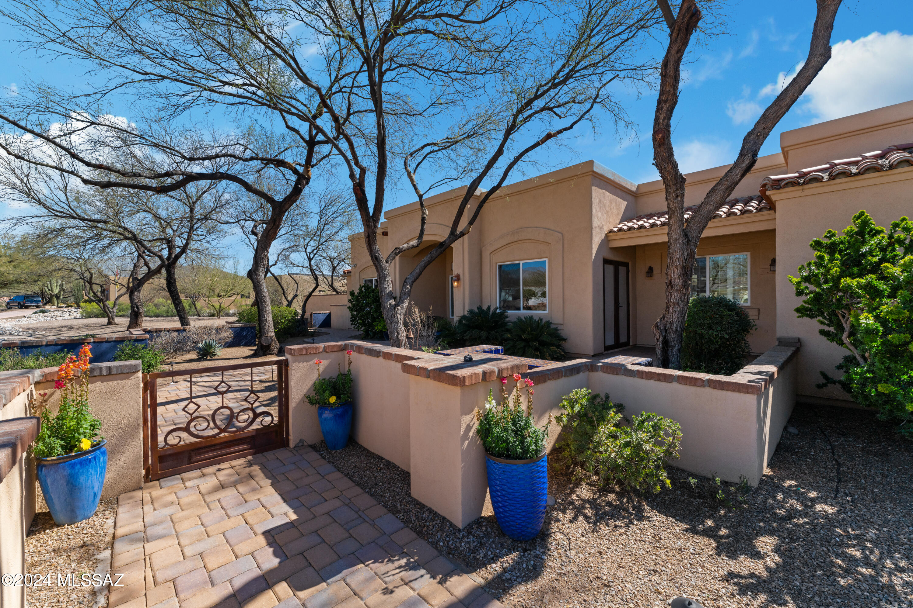 Welcome to this beautiful Forty-Niners Country Club home.  5 bedrooms and 4 full baths on over 1/2 acre!  Large gourmet kitchen offers tons of space plus an enclosed pantry and additional pantry off the laundry room.  6 burner gas stove and Alder cabinets. Second refrigerator in laundry room and  wine fridge next to pantry. Deluxe vinyl plank flooring thru out home.  Split bedroom floor plan.  Primary bedroom has a fireplace that can be enjoyed from the bedroom or soaking in the jetted tub. 2 guest bedrooms have ensuite full baths and last 2 bedrooms share a jack and jill bathroom.  Backyard is professionally landscaped and perfect for entertaining with waterfall and grass area.  Bring your trucks and toys, garage is oversized at 969 sq. ft and is 28.5 deep. Tanque Verde Schools!