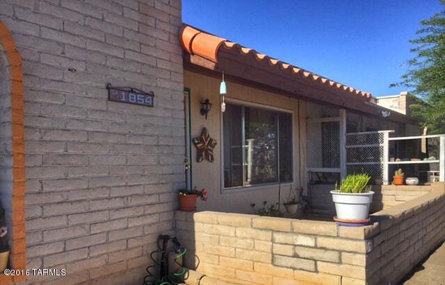 Westside Stunner!! This bright and open townhome, fully remodeled in 2012, boasts over 1000 square feet of living space, 2 spacious bedrooms and 2 beautifully updated bathrooms. The light filled kitchen features solid surface corian countertops, a stainless steel refrigerator, custom mosaic tile work and wonderful open shelving. Delightful details like exquisite laminate flooring, arched entryways, ample storage both inside and out and custom paint make this home truly unique. The fully landscaped corner lot is both low care and charming with lots of easy to manage gravel and both newly planted trees as well as gorgeous mature vegetation. The refreshing, generously sized pool is perfect to relax and cool down on those warm summer days! Priced to sell, this incredible home will not last!!