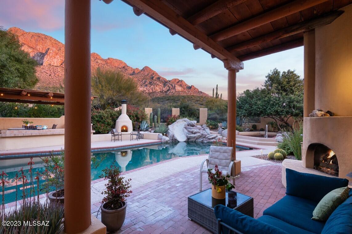Absolutely stunning Southwest 4BR/4BA+office desert home w/superb 1-acre cul-de-sac lot offering peace & tranquility, clear view of stars & sunsets w/stunning Pusch Ridge Catalina Mountain backdrop; secluded yet minutes to shopping, restaurants, hiking & Oro Valley amenities. Perched high in Pusch Ridge Estates, next to Linda Vista Trailhead & Coronado National Forest, the extraordinary orientation captures views of city lights, mountains, sunrises & sunsets. This 5,135sf home includes 983 finished basement w/rec room & 4th BR. Main level has grand entry, formal dining, living area, family room, office & updated Master Bedroom suite by award winning interior designer, Lori Carroll, was featured in Tucson Lifestyle. Updated kitchen has casual dining nook, granite counters, stainless Viking cooktop, wall oven, microwave, built-in desk, pantry cabinet, Sub-Zero refrigerator, ice maker & island w/prep sink. Office has built-in desk/shelving (could be 5th BR). 2 BR's, each w/their own bath, on the upper level. Enjoy outdoor living space w/porches, balconies & patios, putting green, fireplaces, citrus trees, BBQ, Ramada & re-designed pool/spa w/in-floor cleaning, water slide & Kool Deck. 3-car garage. Voluntary HOA only $25/year!