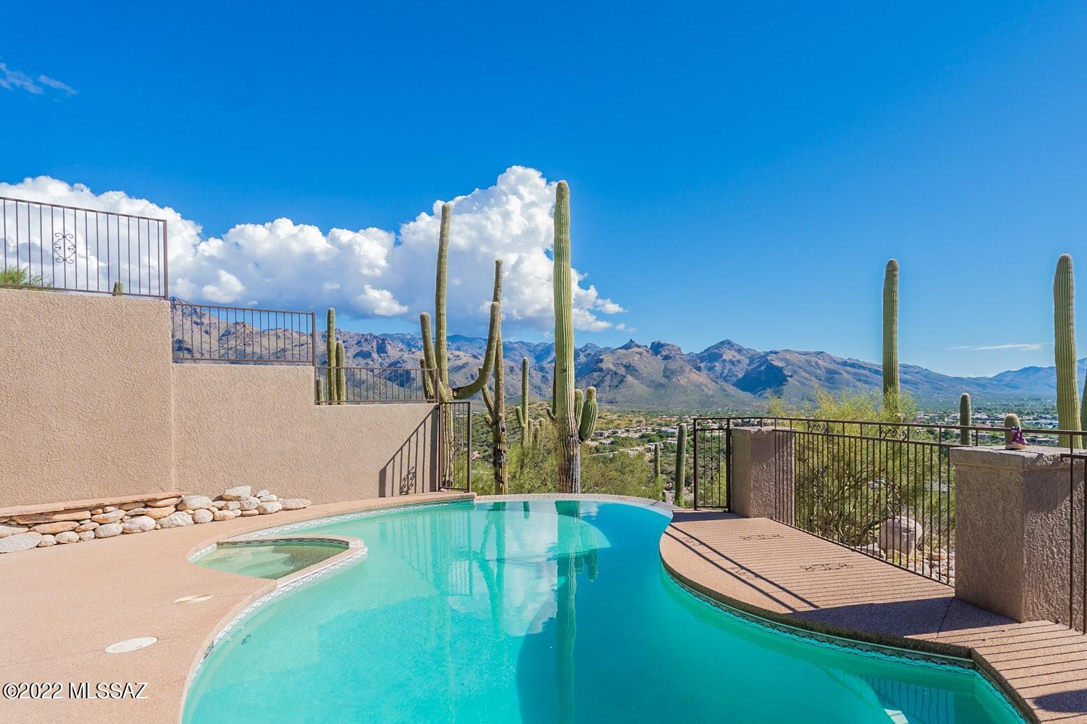 Enjoy spectacular Catalina Mountain and Tucson city light views from this magnificent Foothills home.
This Summit Ridge property features 4 spacious bedrooms, 3 bathrooms, Family room, Living room and sizable Dining room.  An open and quiet courtyard flanked by French doors 
 is accessible from each guest bedroom allowing family and guests privacy and the ability to relax and enjoy our beautiful weather.  Primary suite features two walk-in closets and an updated bathroom with generous walk-in shower. Additionally, the two guest bathrooms have been updated as well, with beautifully appointed finishes.  Walk outside to the back deck, featuring a built in bbq and some of the  most amazing panoramic views in town. Just below, is the spectacular pool, spa and sitting area with an outdoor fireplace to cozy up to for those cooler mornings/evenings and twinkling city light views. Convenient to restaurants, golf and Sabino Canyon Recreation area is what makes this dramatic home a must see.