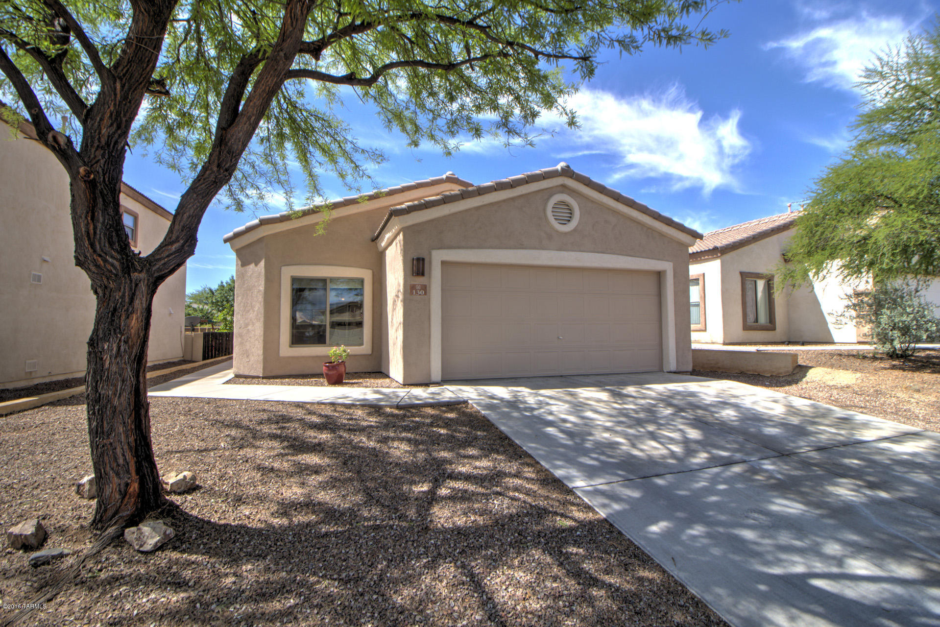 Come experience the resort lifestyle in Rancho Sahuarita, come see this beautiful home built by Richmond American. Located in Presidio Del Oro. Clean, ready to move in is what this beauty offers. 3 bedroom, 2 bathrooms, new carpet, custom paint in the interior and fresh paint in the exterior. The backyard offers a covered patio, custom landscaping pavers and synthetic grass, no rear neighbors. This beauty is within minutes to the splash park, club house, community parks, walking trails and pools.