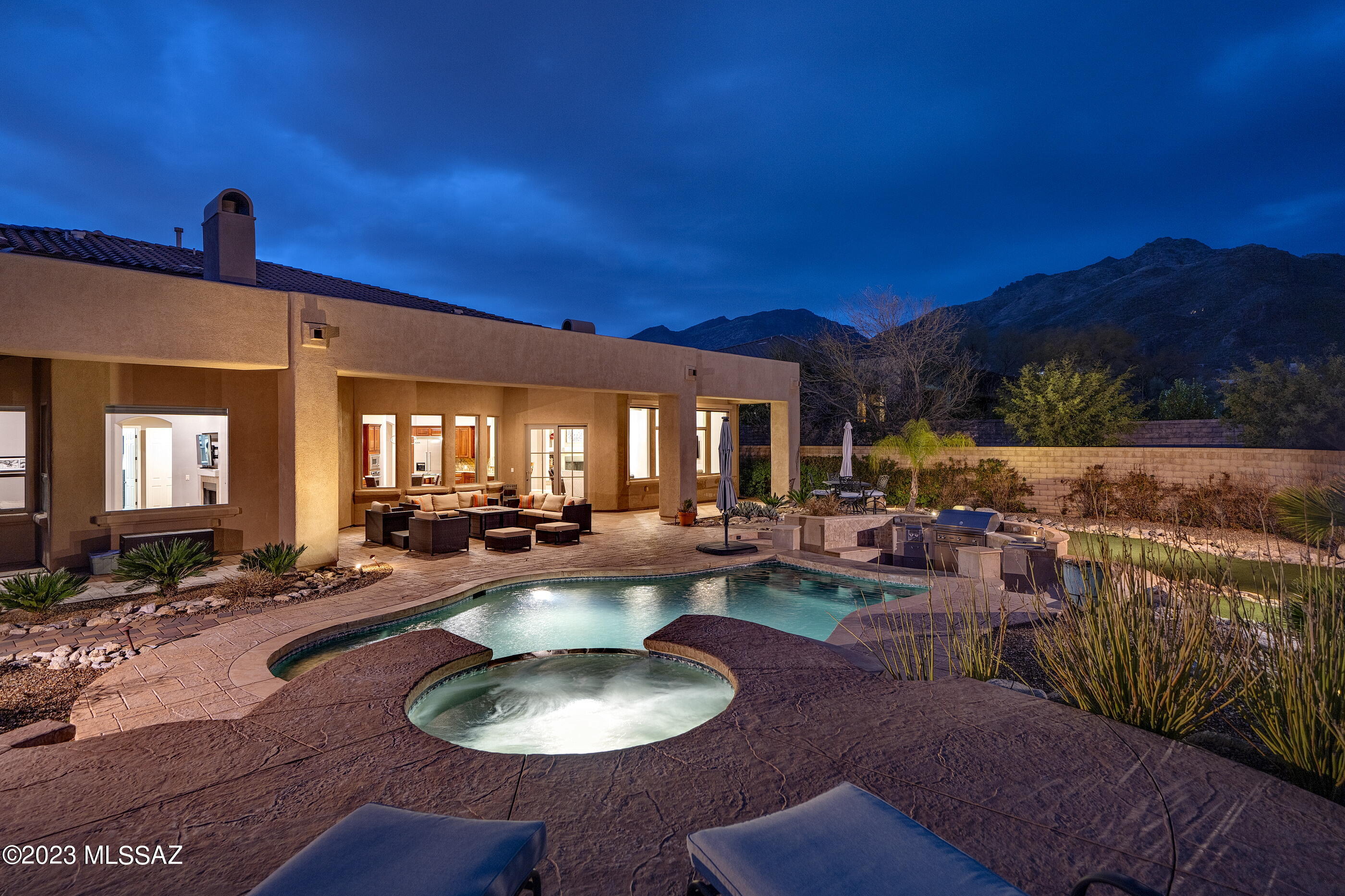 Enjoy dramatic and unobstructed mountain views, overlooking natural desert landscapes from this privately situated AF Sterling built home. Located in the highly desirable gated community of Ventana Reserve, and offering an open, bright, and airy split bedroom floor plan. Featuring 4,586 sq ft, with four bedrooms and four bathrooms, and interior spaces that range from scaled and soaring, to cozy and intimate, taking full advantage of natural light, while blurring the boundaries between the interior and exterior spaces. Soft rounded corners with walls of glass allow the resplendent interiors to expand outward encompassing the sweeping view corridors that frame the surrounding mountain vistas. Upon entry, you are greeted by a central hall that establishes the main connection point of the... home, with natural stone flooring that floats seamlessly throughout the space, providing a subtle contrast to the warm exposed wood tones and textures. 

The heart of the home is the fabulous Chef's style kitchen with gorgeous finishes throughout, including custom wood cabinetry adding warmth to the space, complemented by rich granite countertops, and fitted with top-end Viking appliances. The exquisite custom-tailored breakfast banquet features an array of service counter space, with built-in wine refrigeration, in this kitchen of range and proportion, with the breakfast dinette opening onto the family/living room, creating a highly interactive space.

Sequestered on the primary level of the residence is the owner's suite, complete with a patio walkout and luxurious primary bath, featuring dual vanities, walk-in shower, large soaking tub and oversized dual dressing closets. Three additional secondary suites, as well as a large media/flex room are featured on the upper level of the home, privately situated and perfect for family or guests alike.

Seamless indoor-outdoor entertaining, offers al fresco dining on the expansive veranda, connecting the shared living spaces, with a series of doors coordinated to tie the interior rooms to the spacious outdoor living environments. Layers of elevated patios create the framework for the pool and spa, acting as the centerpiece of the backyard. The pristine grounds create the feeling of being in your own private boutique resort, with stamped concrete pavers that connect the private and social spaces, which include a full outdoor kitchen complete with a barbecue station, cooktop, beverage cooler, sink, and endless counter space, adjacent to the swim up bar and cascading water feature.

Every comfort is considered and detail meticulously crafted, the result being a home that offers a sense of ease to enjoy both the Tucson lifestyle and entertainment.