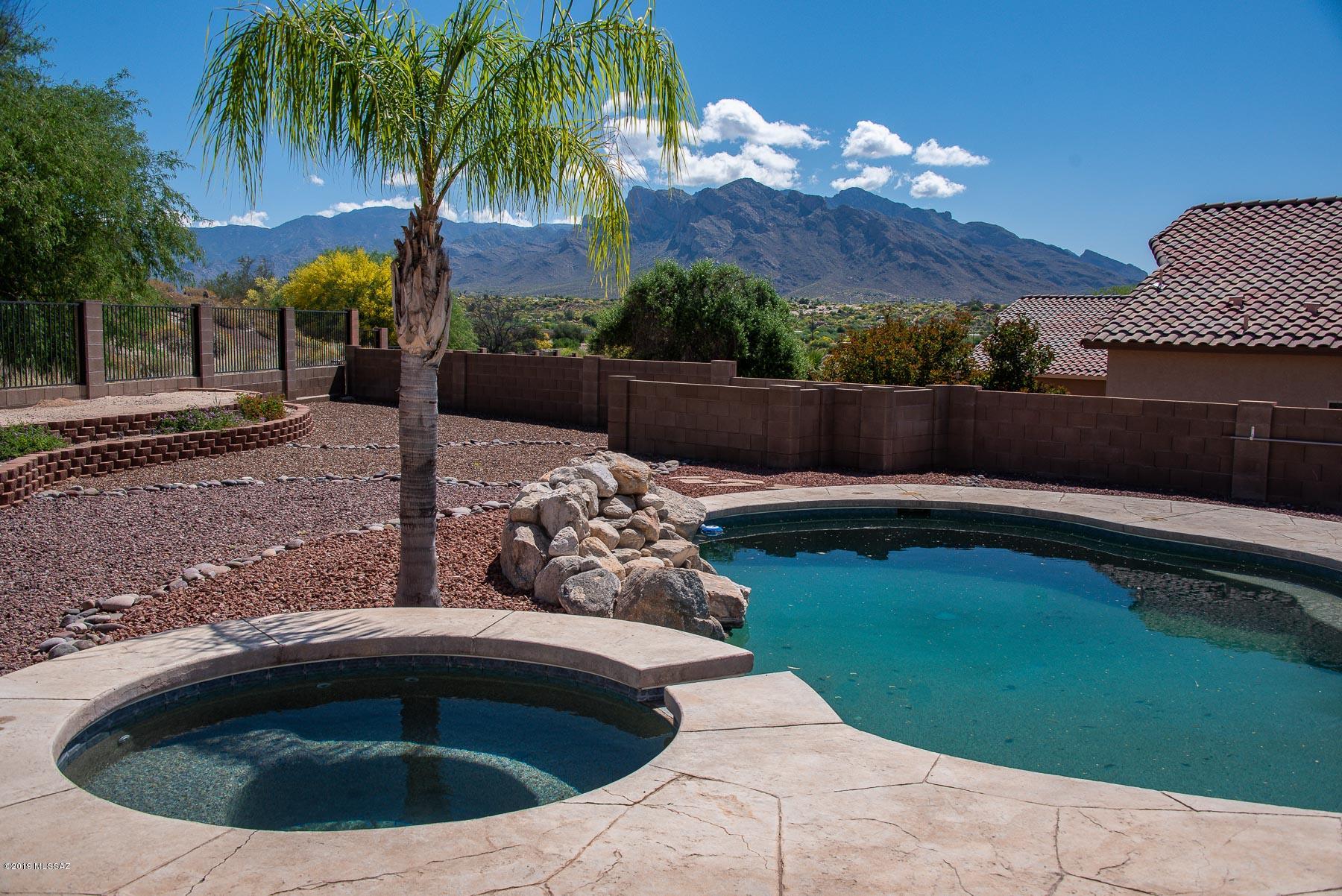What a view!  .28 acre lot, Gated and on a cul-de-sac.  This home sits on top of a ridge that backs to a natural desert area with a pool and spa.  Call to see this home now.  It won't last long.  It has everything buyers are looking for with easy access to all your favorite areas in Tucson.  Popular great room floor plan with a large spacious kitchen and Master suite.  Close to Northwest Hospital. Near Pima Community College NW campus.  The community has a park with play equipment. horse shoes, volley ball and basket ball courts.