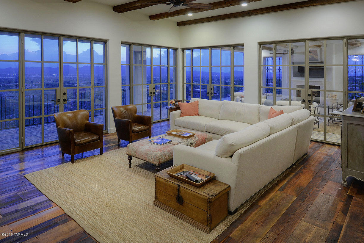 Top of the world views from this stunningly and completely remodeled Mediterranean home. Located high in the central Catalina Foothills, in the gated Foothills II community, this spectacular renovation was led by noted Scottsdale architect Gene Kniaz Of Spiral Architects (formerly of Oz Architects). This 6 bedroom, 4438 sqft home, plus exterior loggia space, offers commanding 360 degree views and city or mountain views from every room. Design themes taken from a number of different warm climate regions surrounding the Mediterranean create an overall feel which is authentic, familiar and comfortable. Antique and reclaimed building materials were used throughout to establish a core-level authenticity, including antique fireplaces, beams, flooring, window surrounds, and other artifacts.