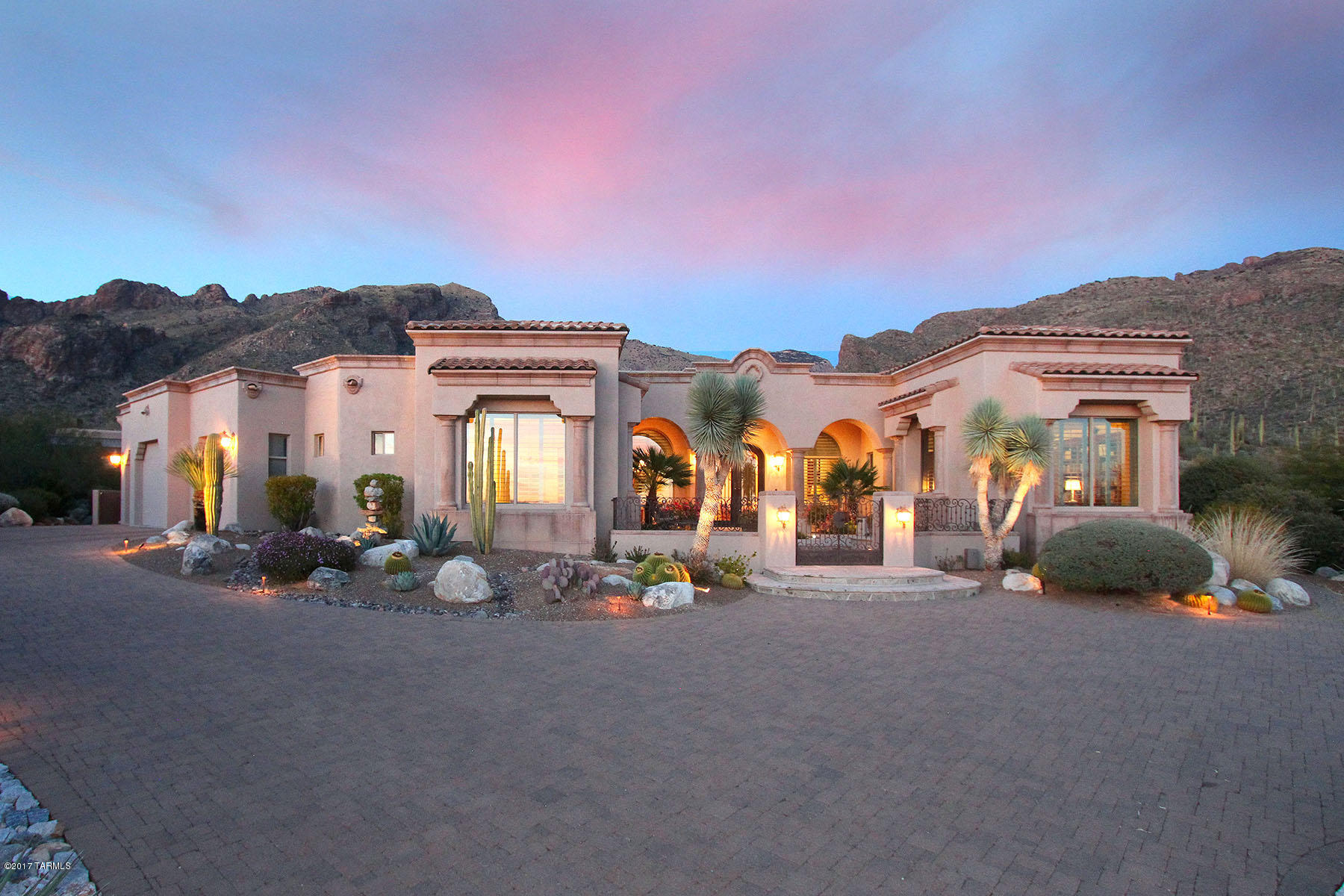 This extraordinary all-masonry custom home thoughtfully designed and built by premier builder, Bill Diamond, is offered for the first time in the coveted gated community of Pima Canyon Estates. Enter home through gated cantera stone courtyard into open living room/dining room w/spectacular Catalina Mtn views. The home incorporates state-of-the-art functionality with amenities that boast second master suite, large studio and  spacious chef's kitchen adjoining family room with massive fireplace w/custom carved wood mantle. The perfectly proportioned rooms have high ceilings, viga beams in living & dining rooms, all bedrooms w/ensuite baths & Tera Rosa ceramic flooring throughout home. Entertain in resort style all Cantera stone back yard patio & pool area w/built-in FP & BBQ.